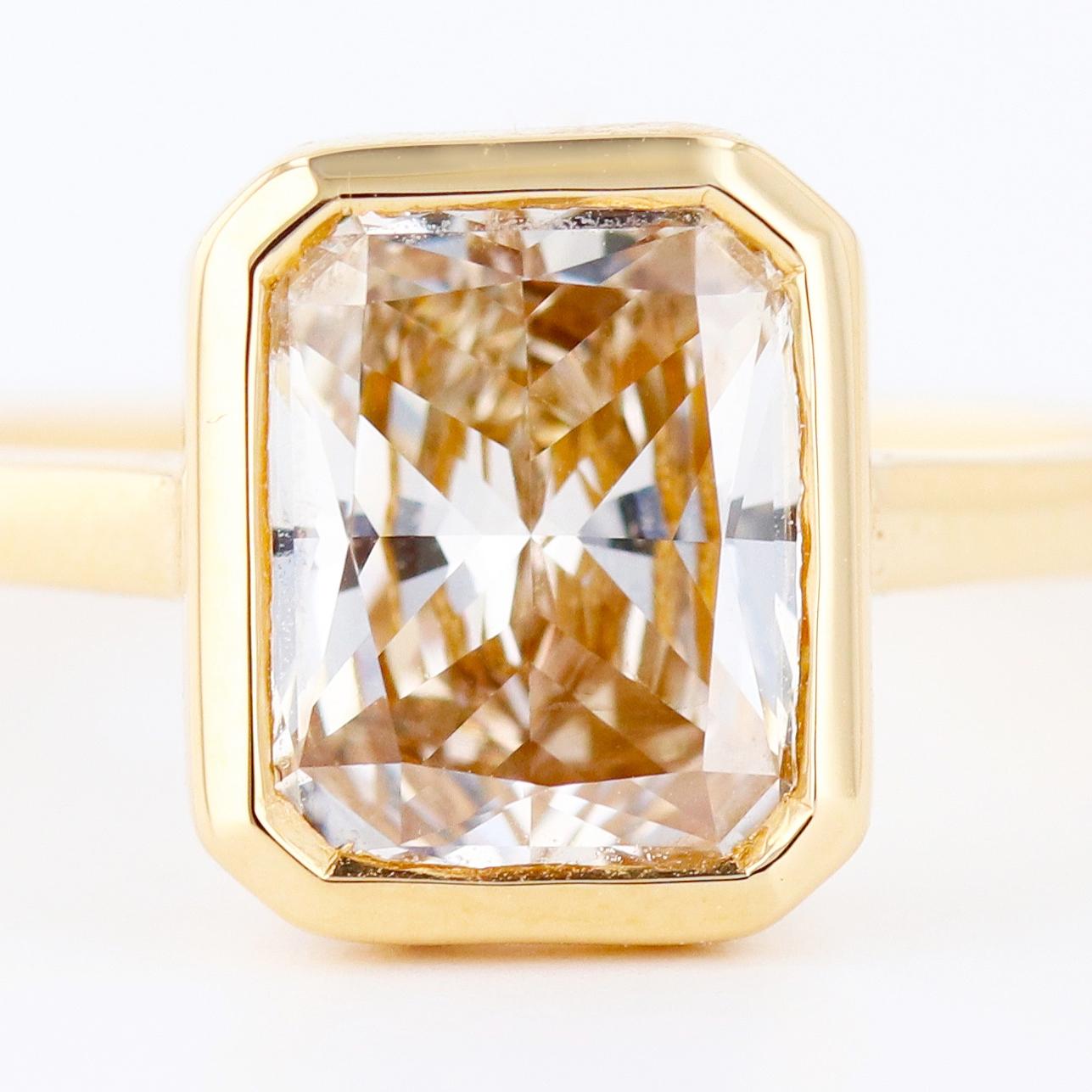 2.09 carat sparkling champagne radiant cut diamond meticulously bezel set in 18k yellow gold.
Perfect for the modern bride, or the woman looking to add a little bit of flare to her jewelry collection. 

Designed by ORIANNE 

EGL USA certified VS2 N