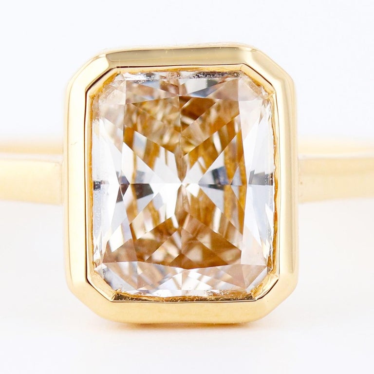 2.09 carat sparkling champagne radiant cut diamond meticulously bezel set in 18k yellow gold.
Perfect for the modern bride, or the woman looking to add a little bit of flare to her jewelry collection. 

Designed by ORIANNE 

EGL USA certified VS2 N