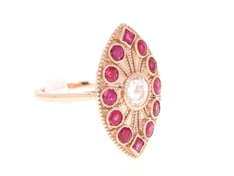 A real statement piece - Ruby and Rose Cut Diamond Cocktail Ring in 14 Karat Rose Gold!
This ring has a stunning Rose Cut Diamond that weighs 0.39 Carats and has 12 Round Cut Rubies that weigh 1.70 Carats.  The Total Carat Weight of the Ring is 2.09