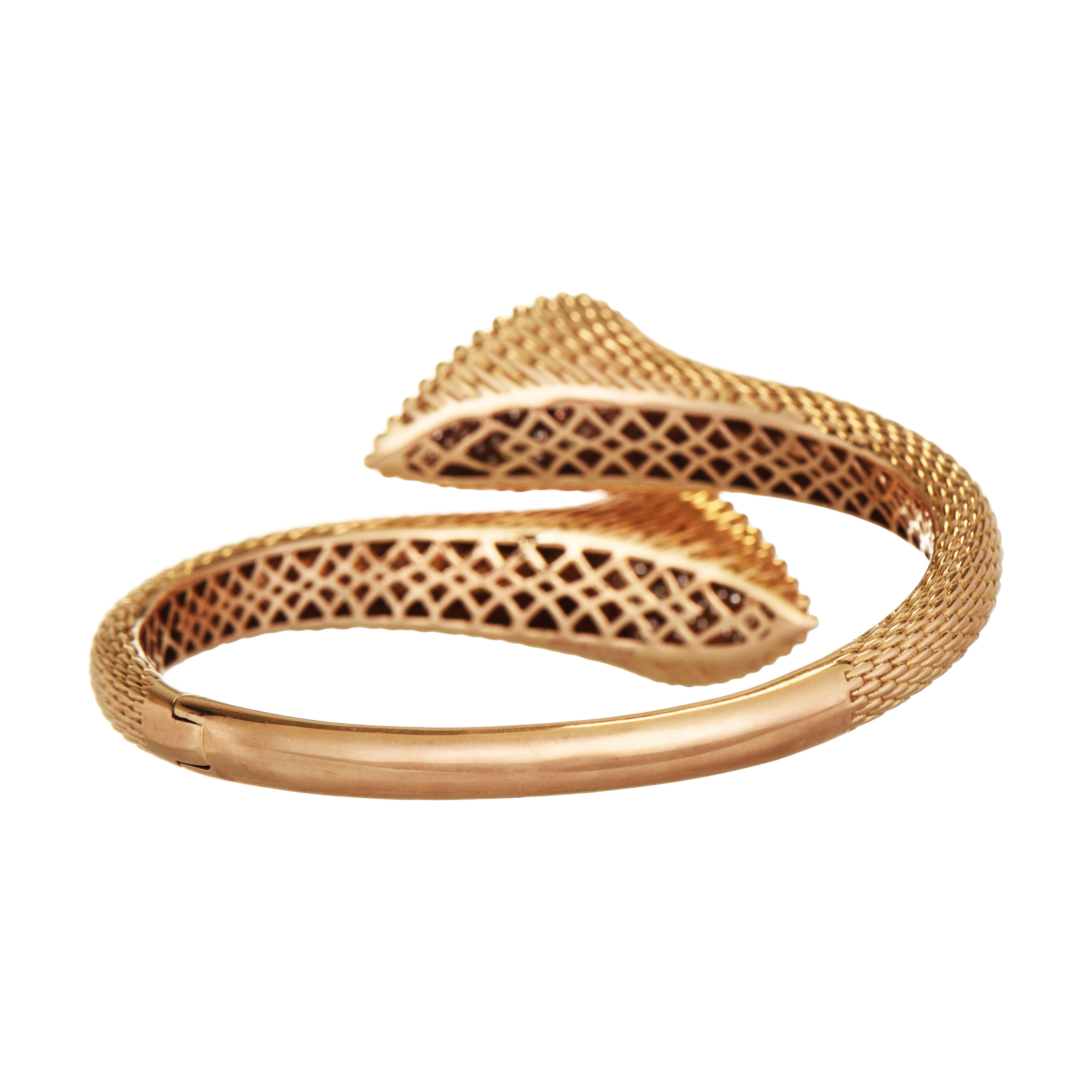 This beautiful rose gold bangle showcases dual pear shaped ends, one with pink diamonds set in rose gold and one with white diamonds set in white gold, both pavé set.

93 Pink Diamonds: 1.14 Carats, Round Cut
93 White Diamonds: 0.95 Carat, Round