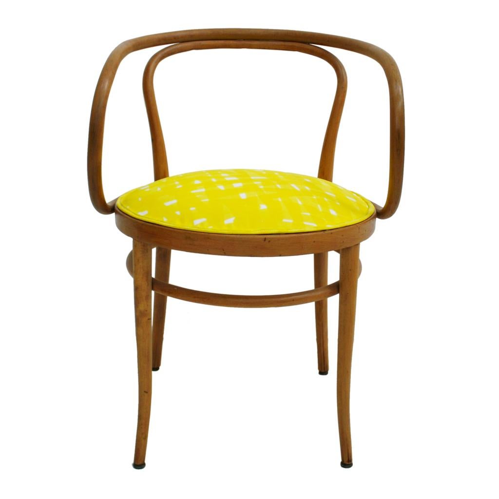 A bold and original midcentury set of eight dining chairs model 209, designed by August Thonet in the year 1900. 
Made in solid birch wood and composed of a curved backrest and armrest open and curved arms. Seat upholstered in yellow and white hand