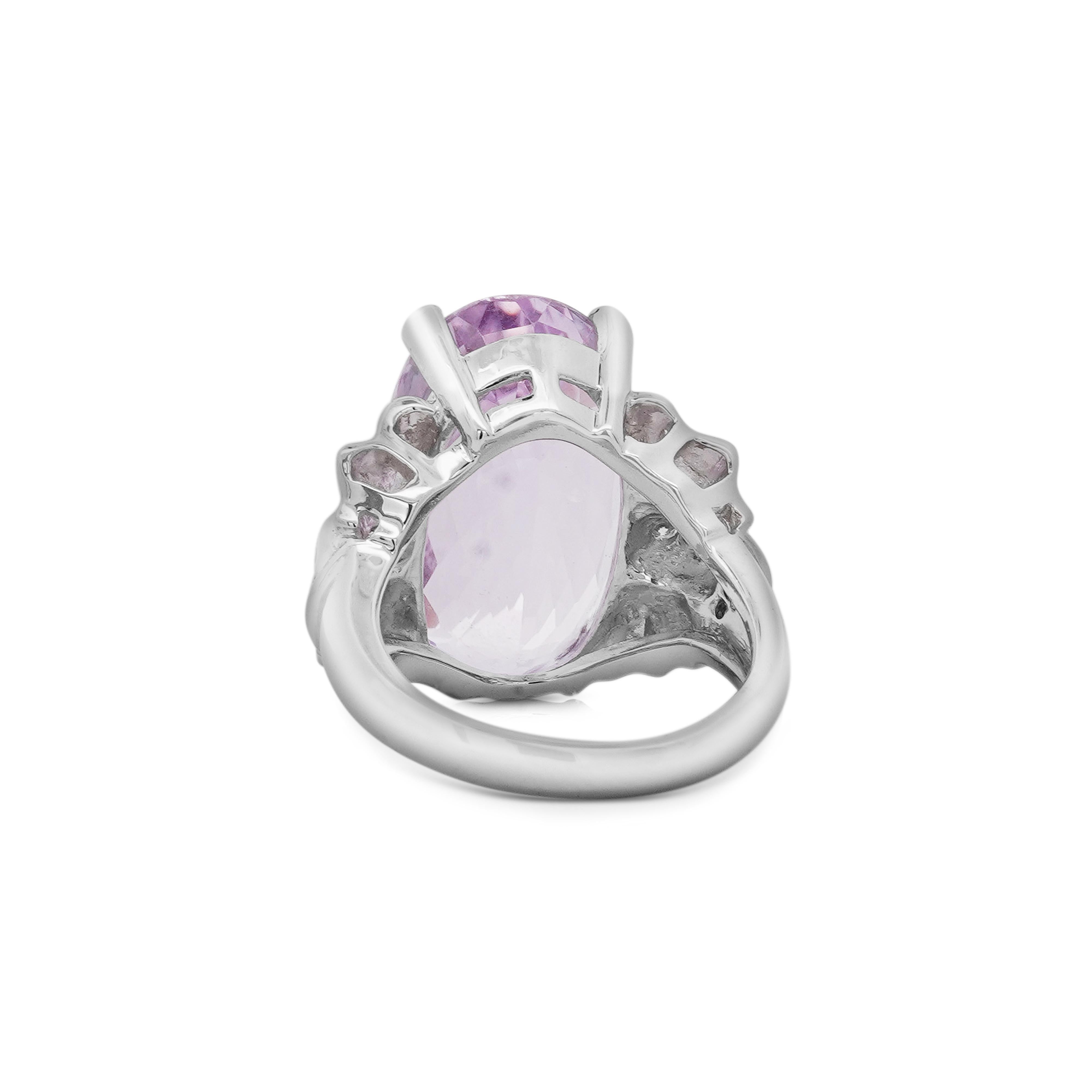20.96-carat oval-cut light pink kunzite, surrounded by 0.28 carats total weight of round-cut halo diamonds, set in a delicate platinum filigree design for a refined and timeless look.

Details: 
Item Type: Statement Ring
Metal: Platinum