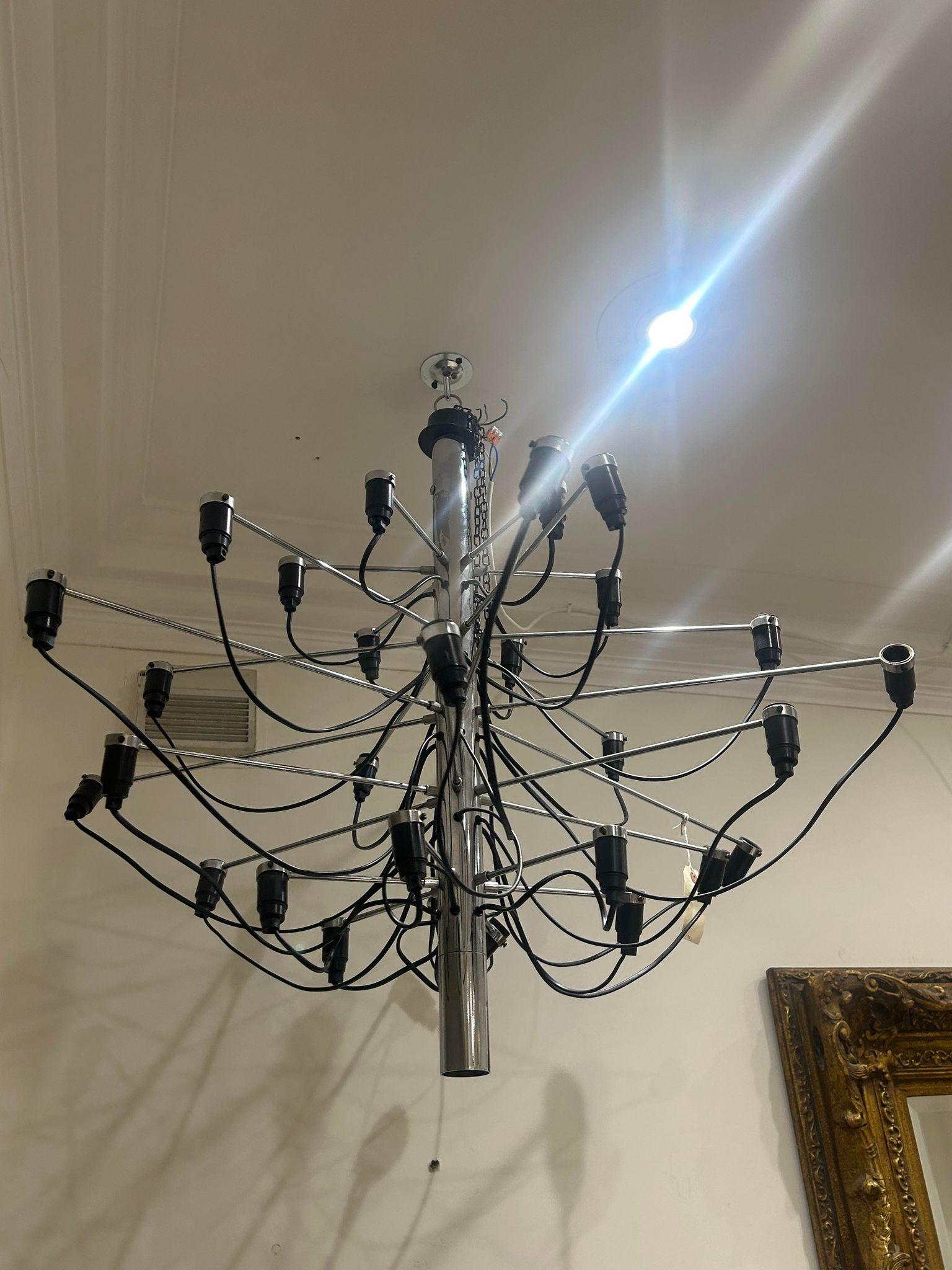 Since 1958, this iconic Gino Sarfatti design has served as an ultra-modern representation of the traditional mid-century chandelier. 

Every detail of this state-of-the-art ceiling light is exceptional, from the mirror-polish finish of its main