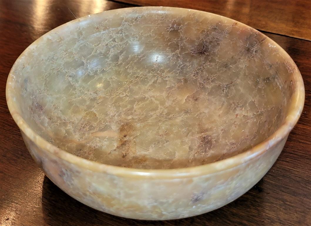 Presenting a lovely 20C Chinese soapstone polished bowl.

Made in China in the early 20th century circa 1930.

This is a medium sized jade green and brown soapstone hand carved and highly polished bowl.

In very good original condition with no