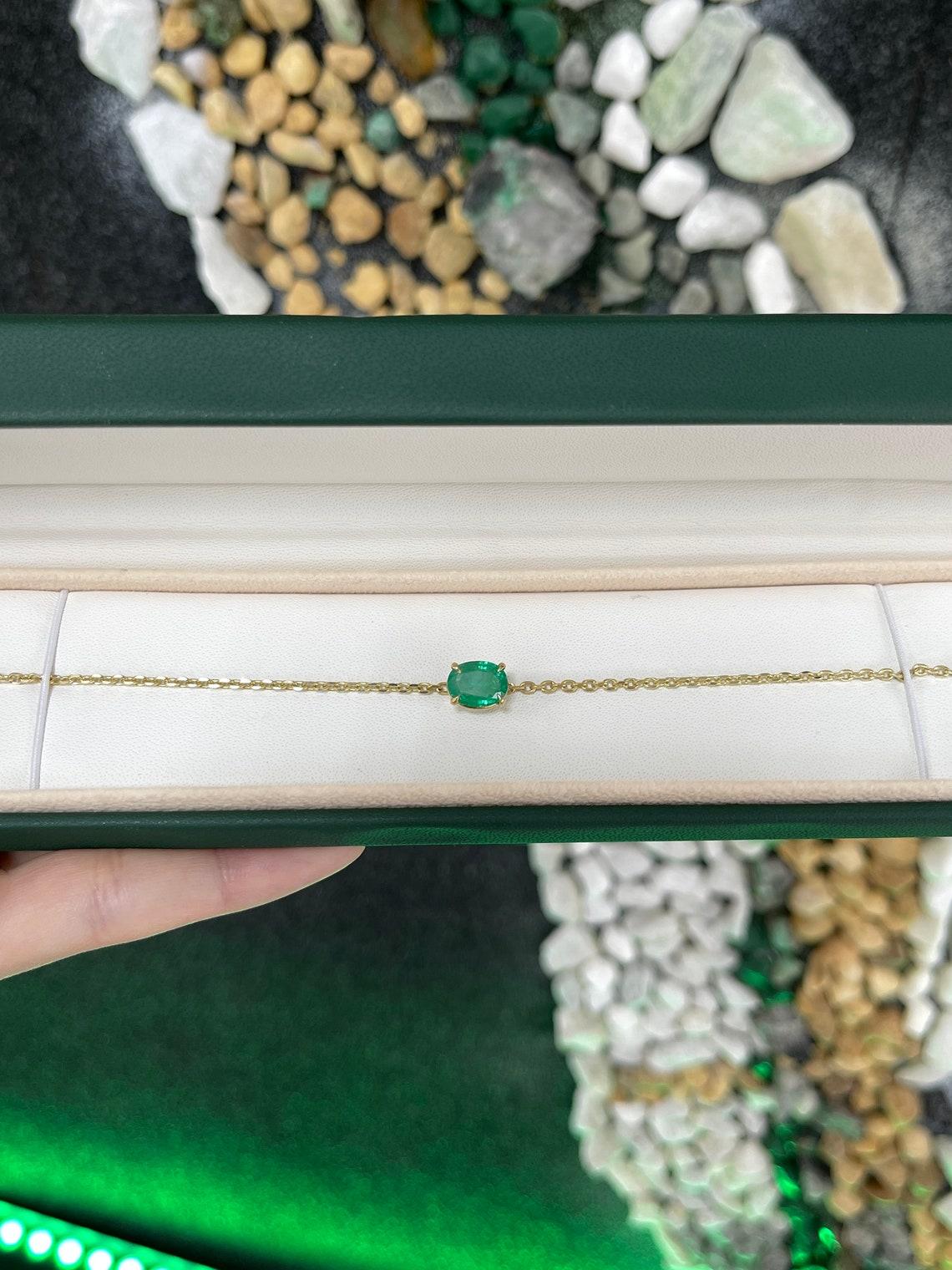 A gorgeous solitaire emerald bracelet. This piece features a remarkable oval-cut emerald weighing two full carats of pure emerald green bliss. The gemstone showcases a ravishing vivid medium-dark green color with very good clarity and luster. Set in