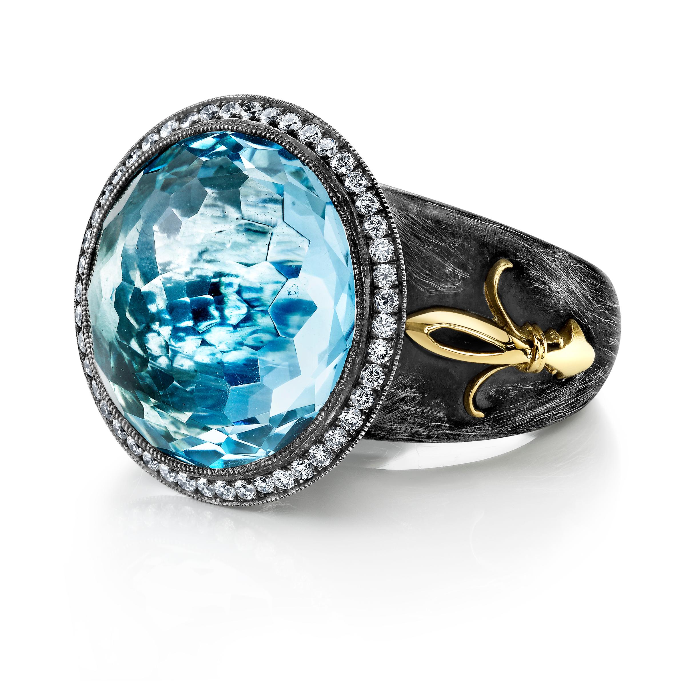 Introducing the Organic Silver and Blue Topaz Ring with a stunning Fleur De Lis design in 18 Karat Yellow Gold. This breathtaking piece of jewelry showcases a 20+ CT Blue Topaz center stone, surrounded by sparkling 0.43 CT diamonds that add an extra