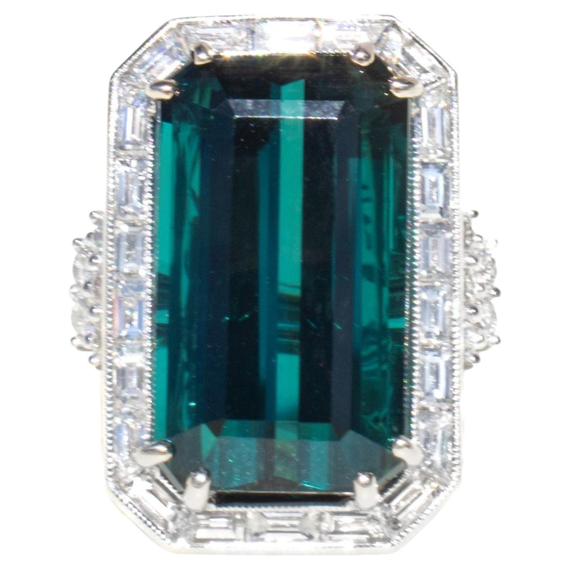 This gemstone is both rare and spectacular. It is a large, rare, 20 carat 'popsicle blue' indicolite tourmaline from the mountains of Kashmir. 

To properly showcase this spectacular gemstone, we designed an 18K white gold setting with magnificent