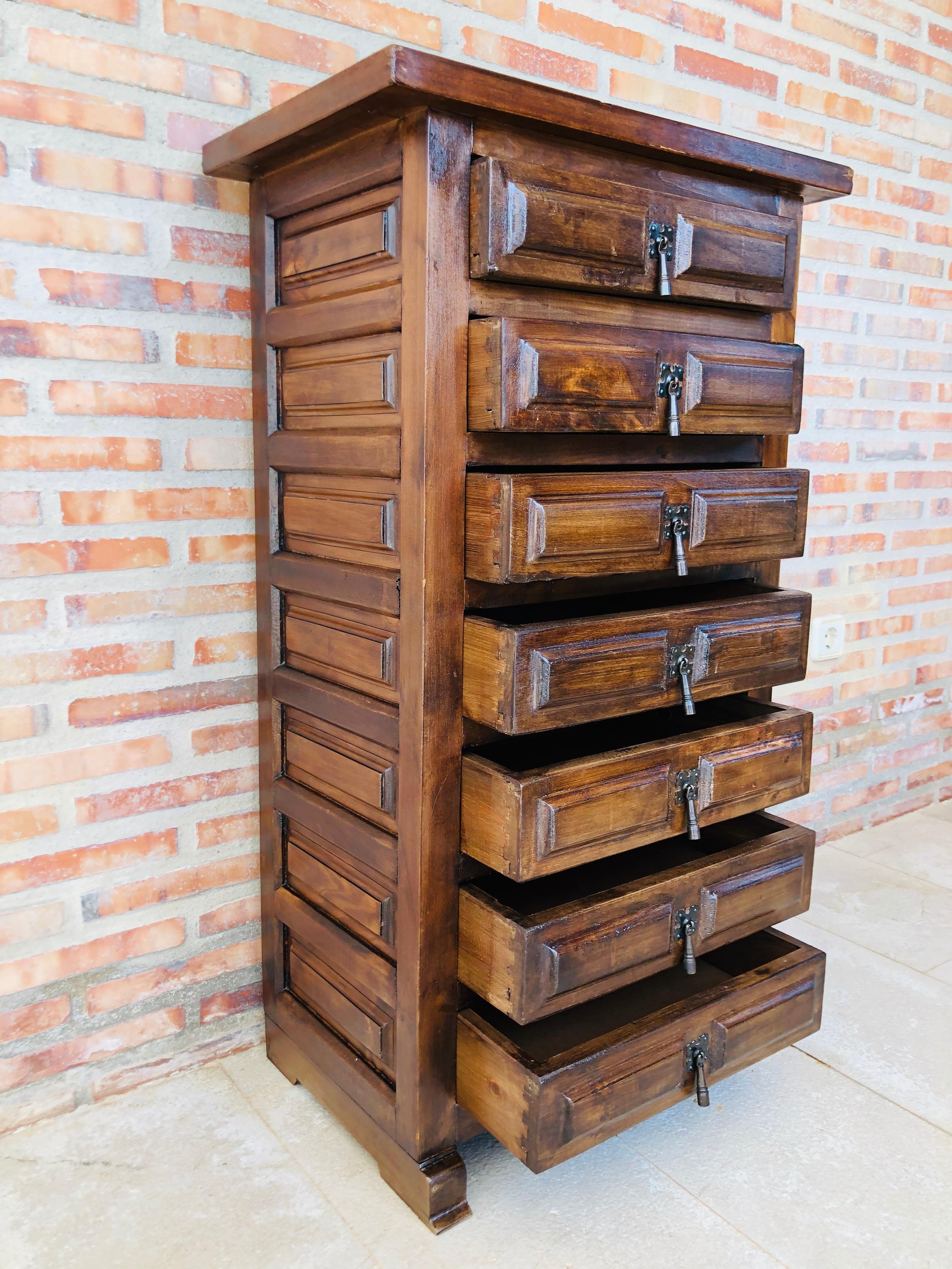 From Northern Spain, constructed of solid walnut, the rectangular top with molded edge atop a conforming case housing seven drawers with solid walnut, raised on a plinth base.

  