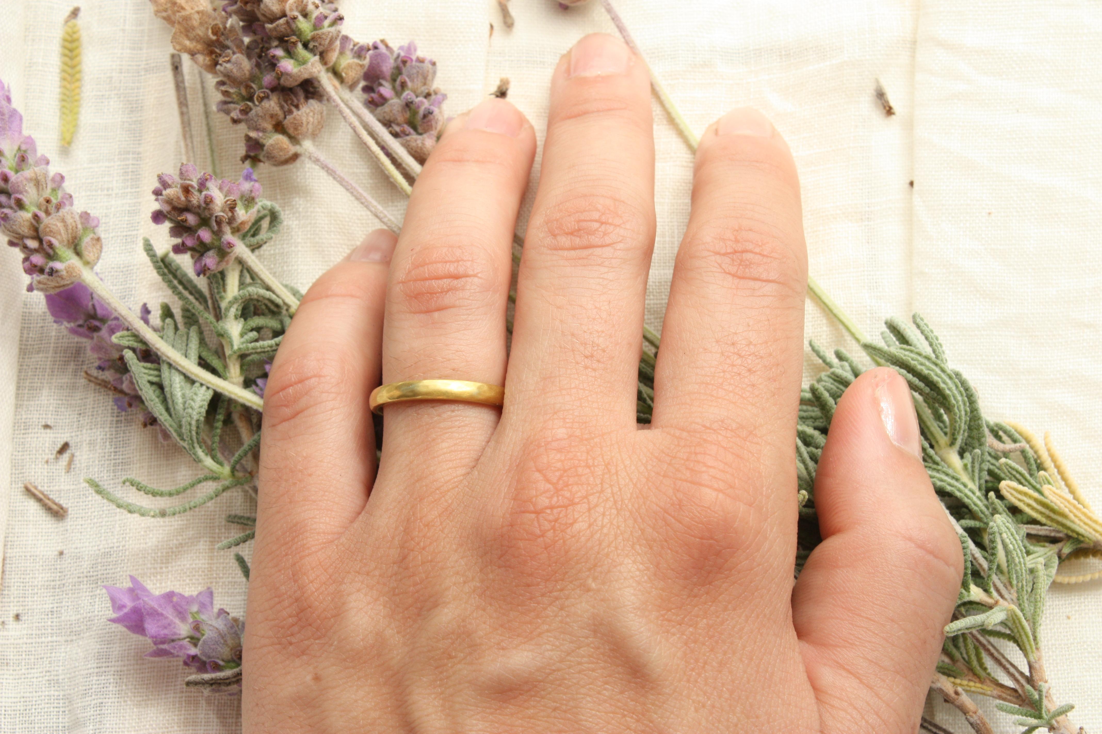 This thin 20k hammered gold wedding band is handcrafted from 100% natural California gold by Bracken Jewelers in Venice, California. Named 