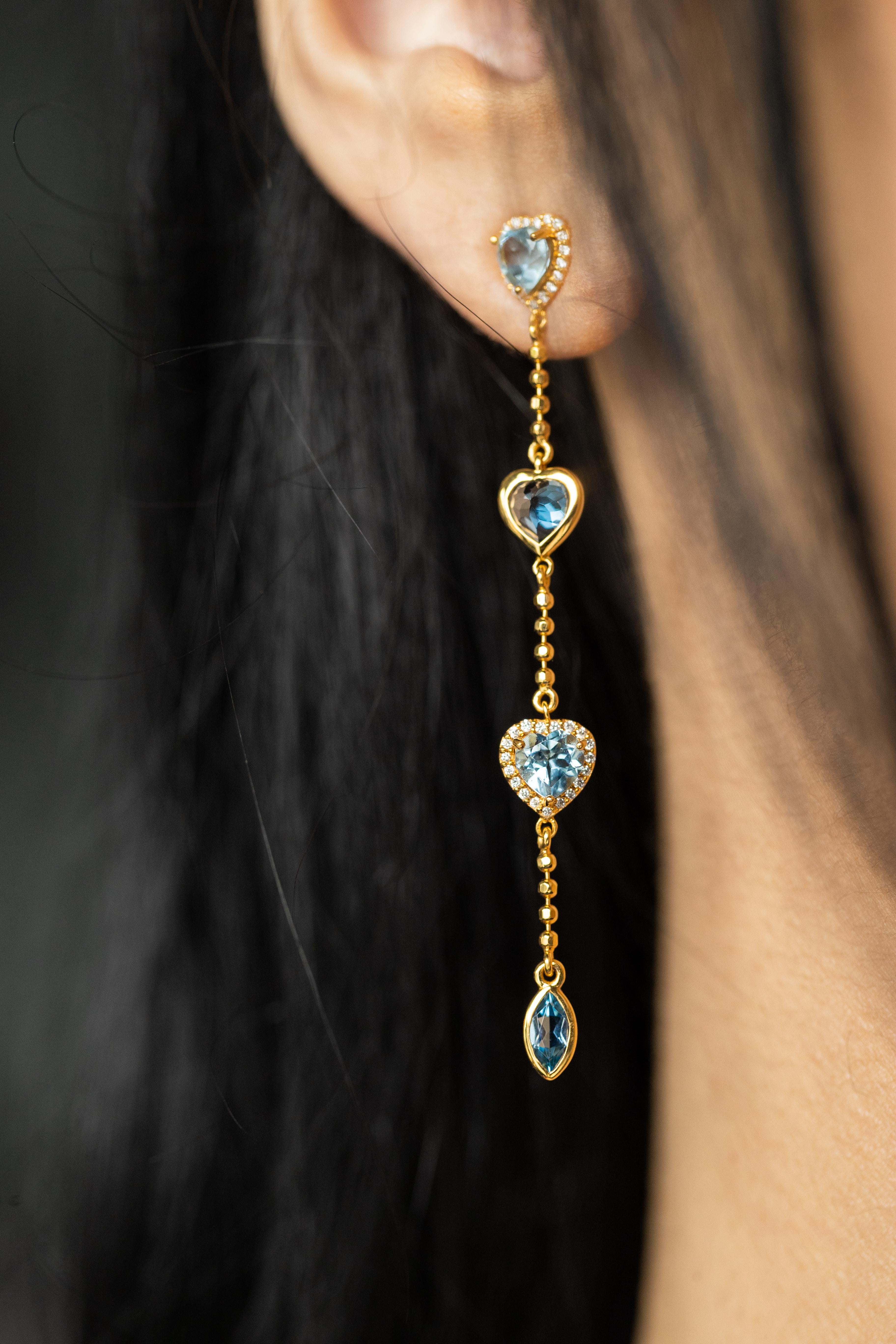 20K Yellow Gold Aquamarine Heart Earrings featuring 2.76ctw aquamarine hearts framed by sparkling diamonds and marquise accents totaling 0.23ctw. These exquisite earrings, measuring 63MM, are meticulously crafted to embody timeless elegance and