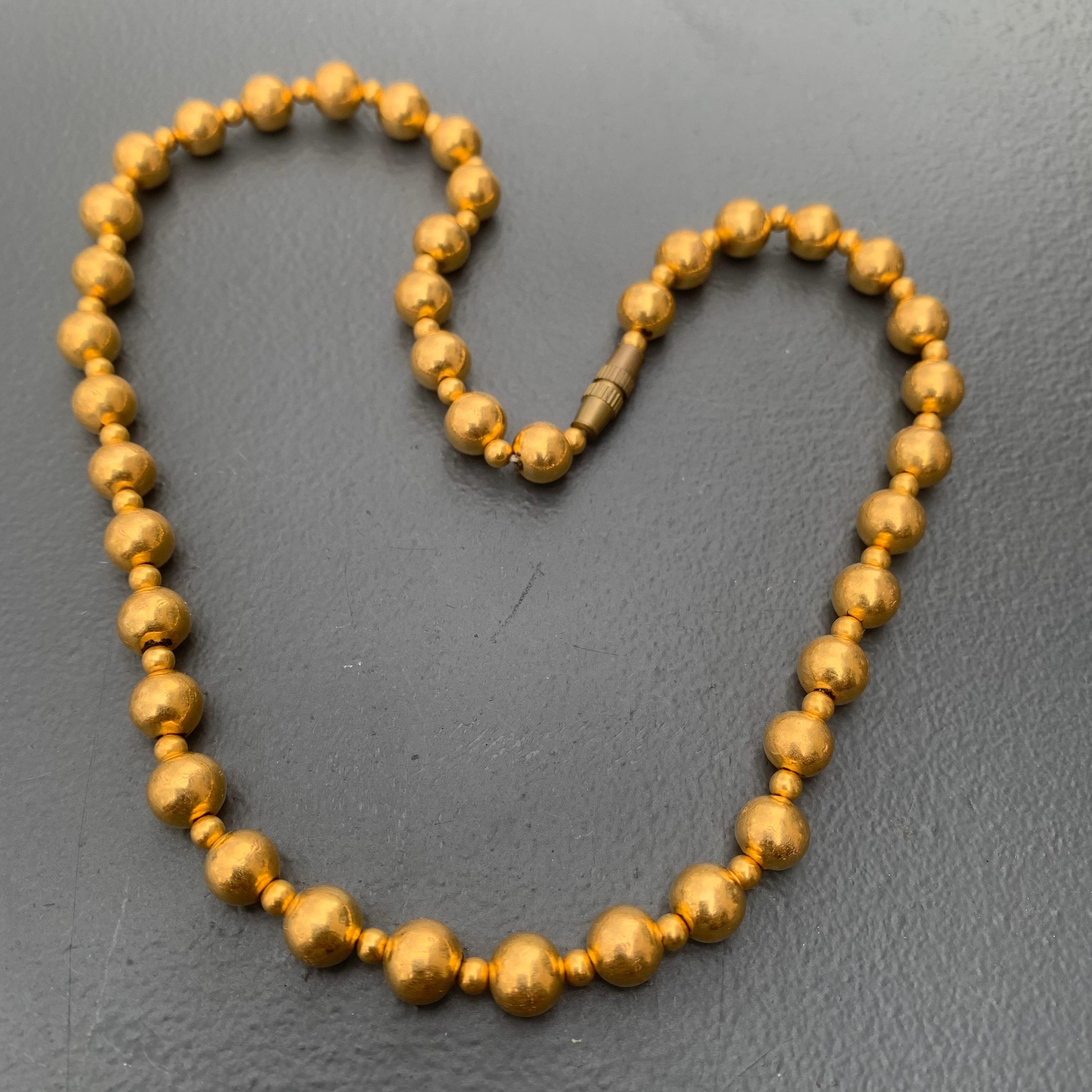 Vintage classic yellow 20kt wax filled round ball beaded choker necklace . Necklace is hand made in India with two size of beads and barrel clasp (not gold made of brass ).
Each bead is made of think layer of gold foil with wax/lac inside . Its not