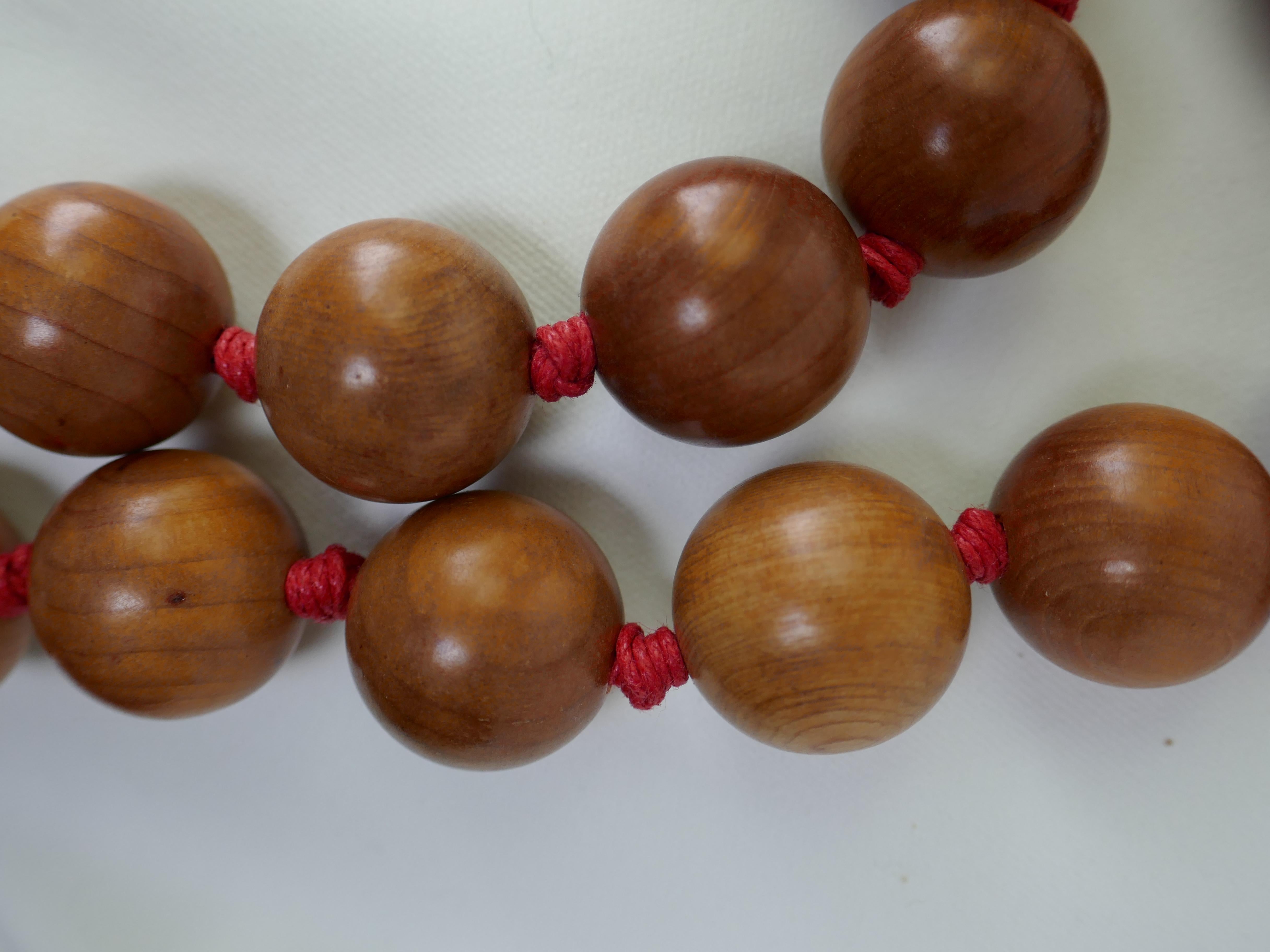These are two necklace that may be worn together of separately. Worn together they make a stunning statement necklace. The wood beads are 20mm.  The carved jasper piece is 60mm 45mm.  The plain wood necklace is 21 inches in length and individually