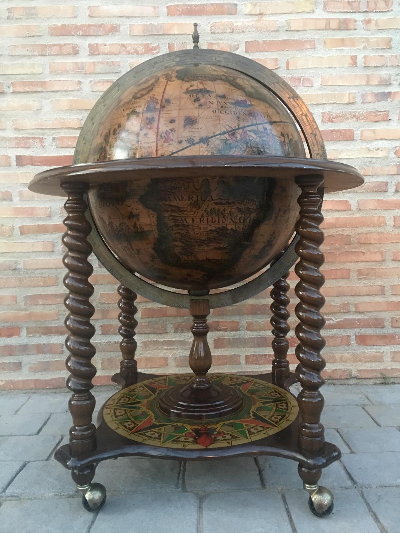 This is a modernist midcentury cocktail drinks cabinet in the form of a globe, circa 1920 in date.

The hinged top section opens to reveal a fitted interior with spaces for glasses and a ice bucket. 

The exterior of the globe has the map of the