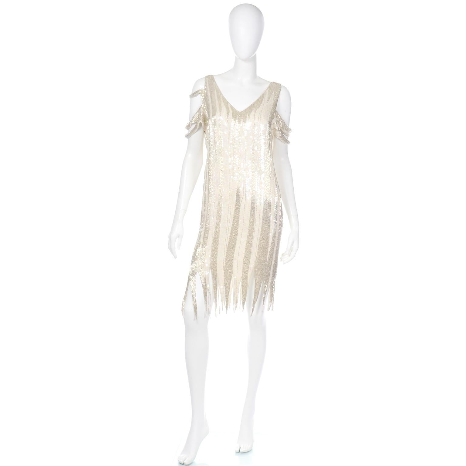 This is an elegant vintage fully beaded ivory silk evening dress that was inspired by 1920's flappers. We sometimes find that some of the lesser known or unlabeled pieces we come across are the most interesting!  The dress is covered with lovely