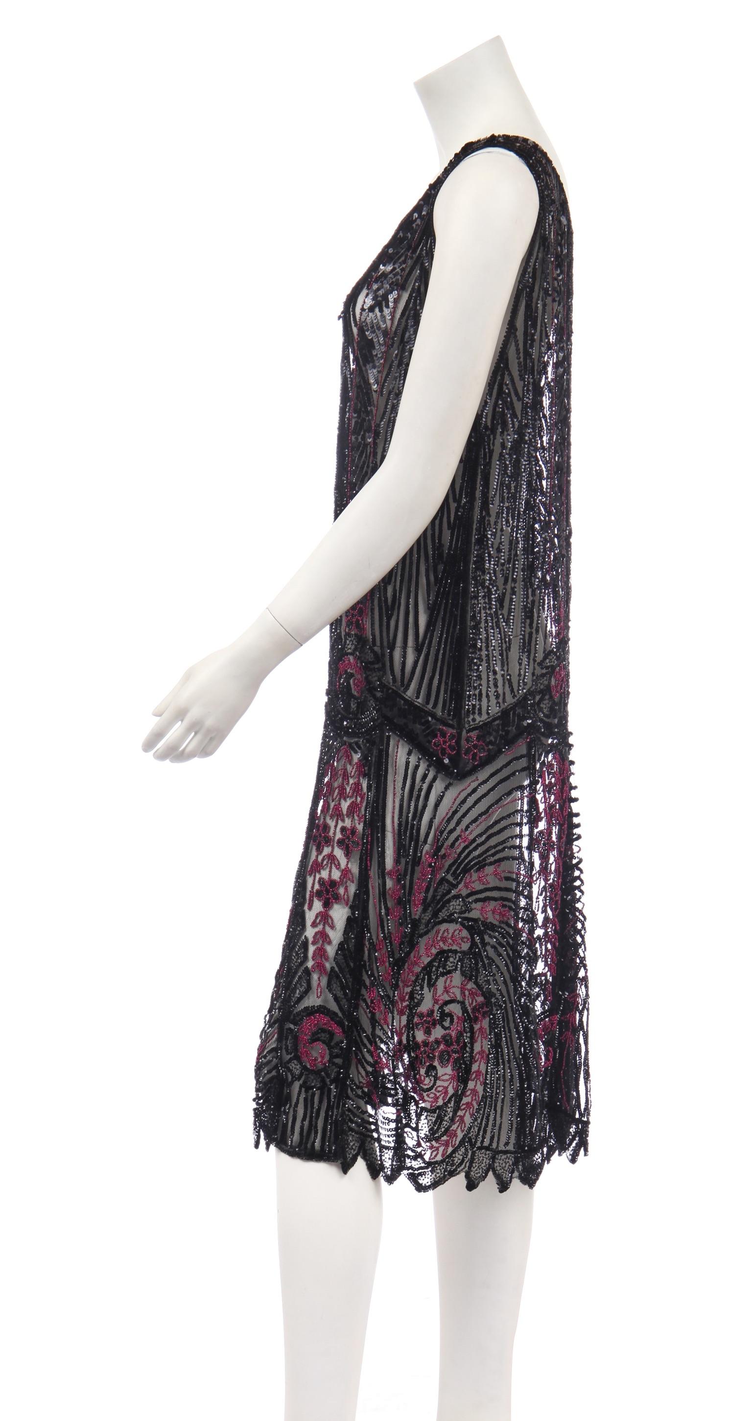 - 1920s Beaded flapper dress
- Black tule embellished with incredible 
  sequin and bead work
- Great Gatsby style
- Size .......
- Sold by Mae Vintage London

