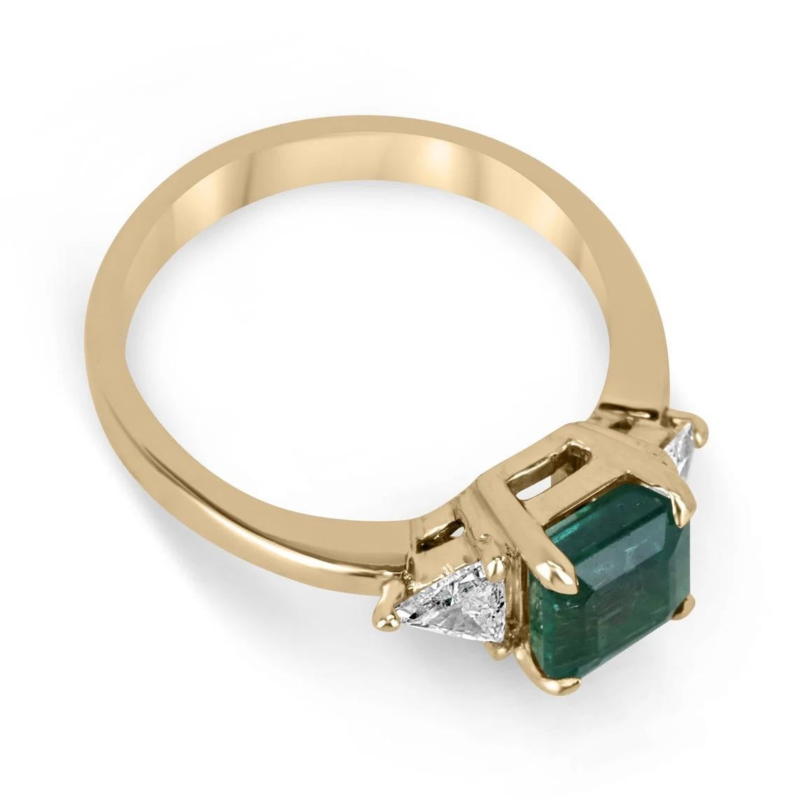 A stunning emerald and diamond three-stone ring. This masterpiece features a remarkable natural, Asscher cut emerald from the origin of Zambia. The gemstone displays a lush green color with very good clarity and luster. Natural inclusions within the