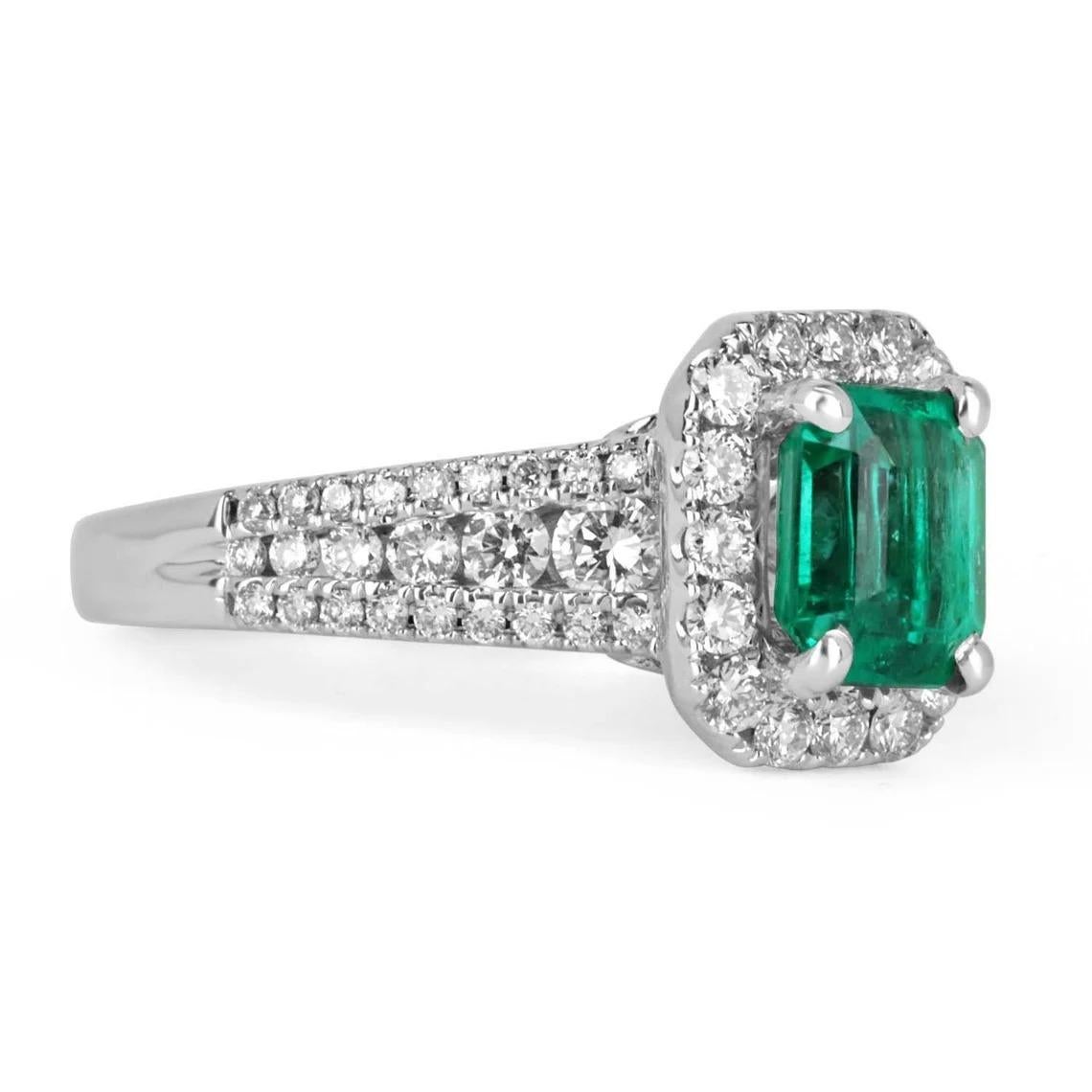 Elegantly displayed is a fine quality, Colombian emerald, and diamond halo engagement ring. The center gem is a high-quality emerald cut emerald filled with life and brilliance! Among the impressive qualities of the emerald, bluish-green color and