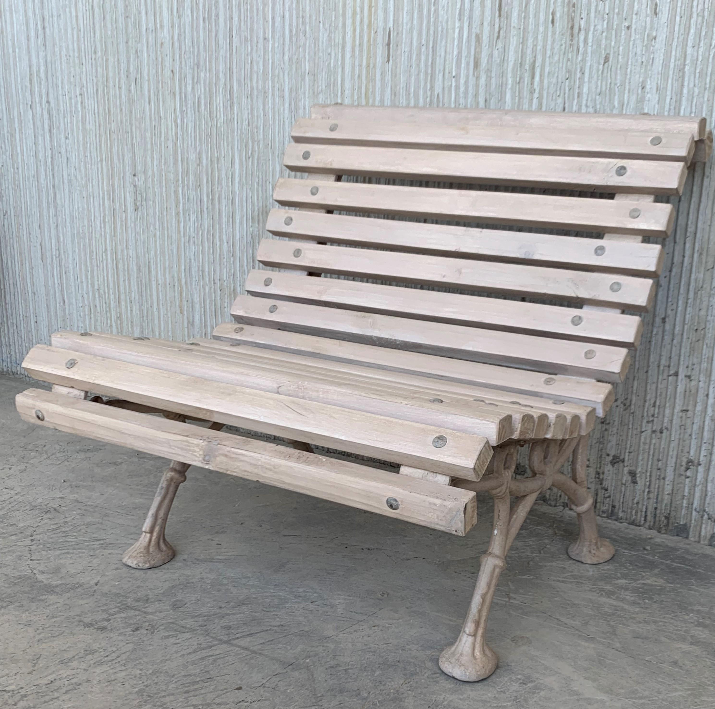 Beautiful old park bench, circa 1900 (Düsseldorfer Hofgarten) with cast-iron feet. In the turmoil of the Second World War, the wooden strips of park benches in Germany were partly used as firewood. After the war, these wooden strips were replaced to