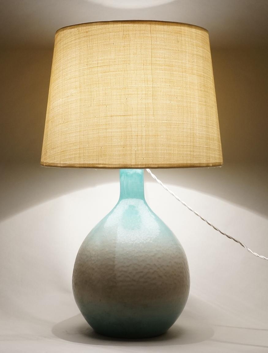 Blue enameled ceramic table lamp.
Custom made upholstered lampshade in abaca
Rewired with twisted silk cord
Measures: Ceramic height: 33 cm - 13in
Height with lampshade: 56 cm - 22in.