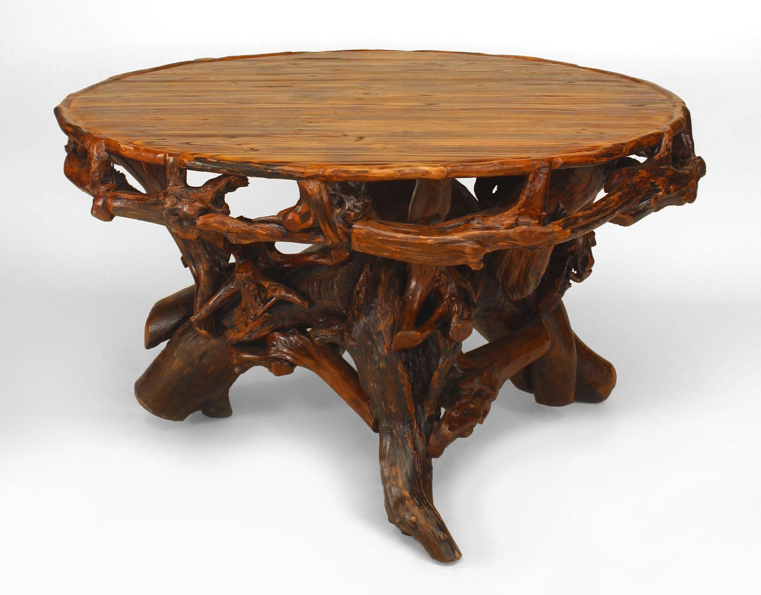 Rustic Adirondack-style (Modern) round dining table with root pedestal base supported on 3 legs with a filigree apron.
