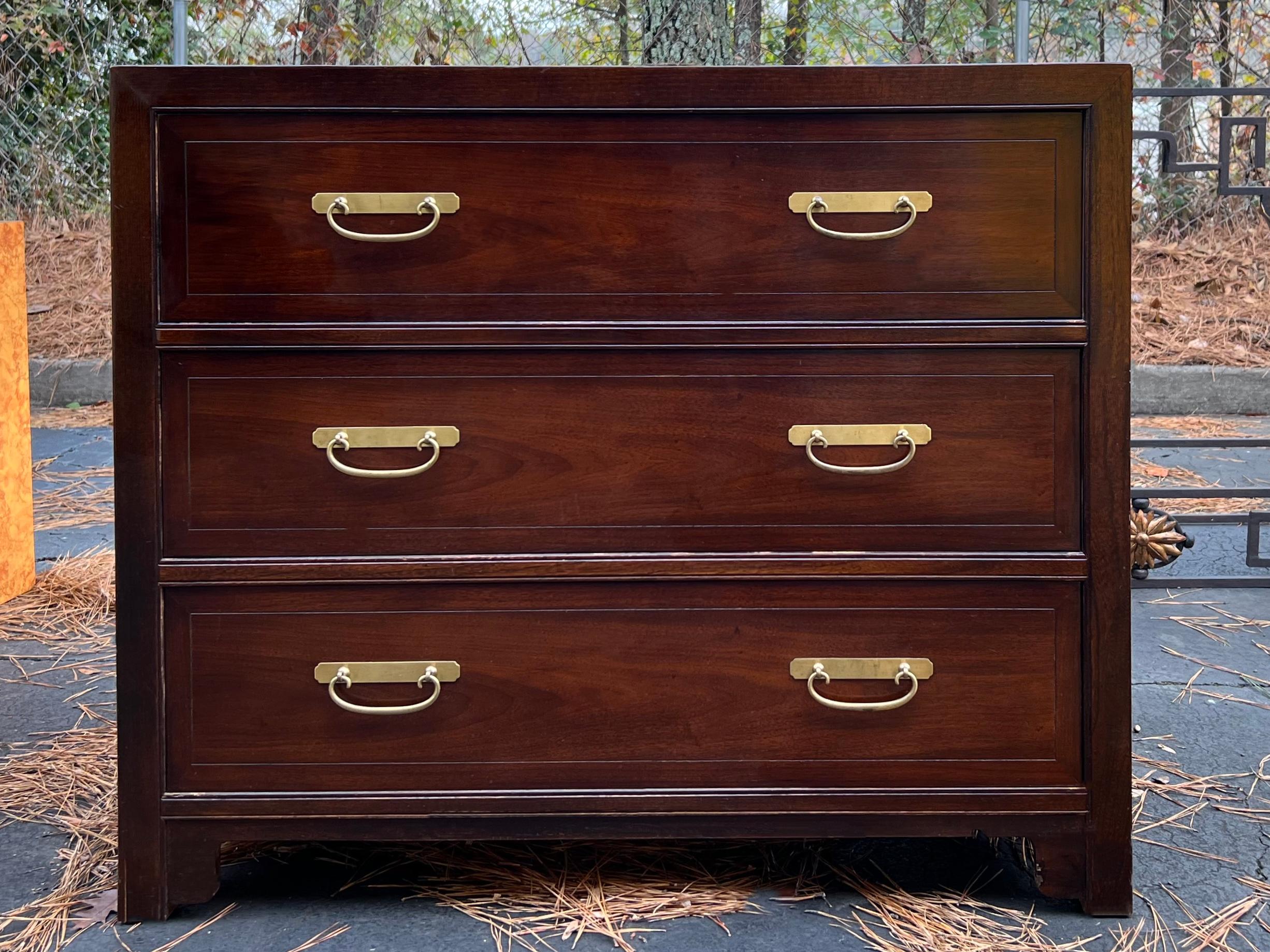 Baker Furniture always represents the best of American manufacturing! This is a pair of carved mahogany bachelor’s chests with Ming styling. They are in very good condition. The hardware is original, and they have dovetail construction.