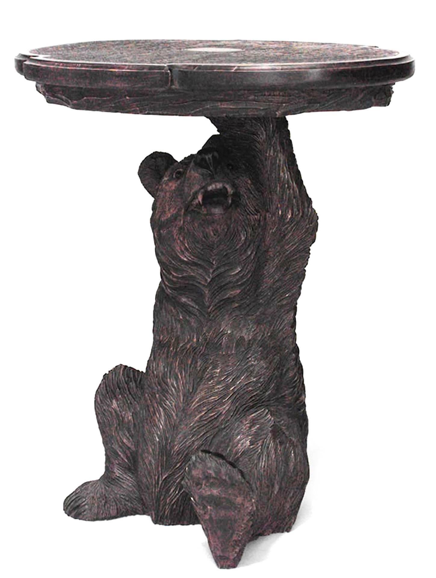 Twentieth century Black Forest style walnut end table with a bear-form base supporting a shaped oval top.