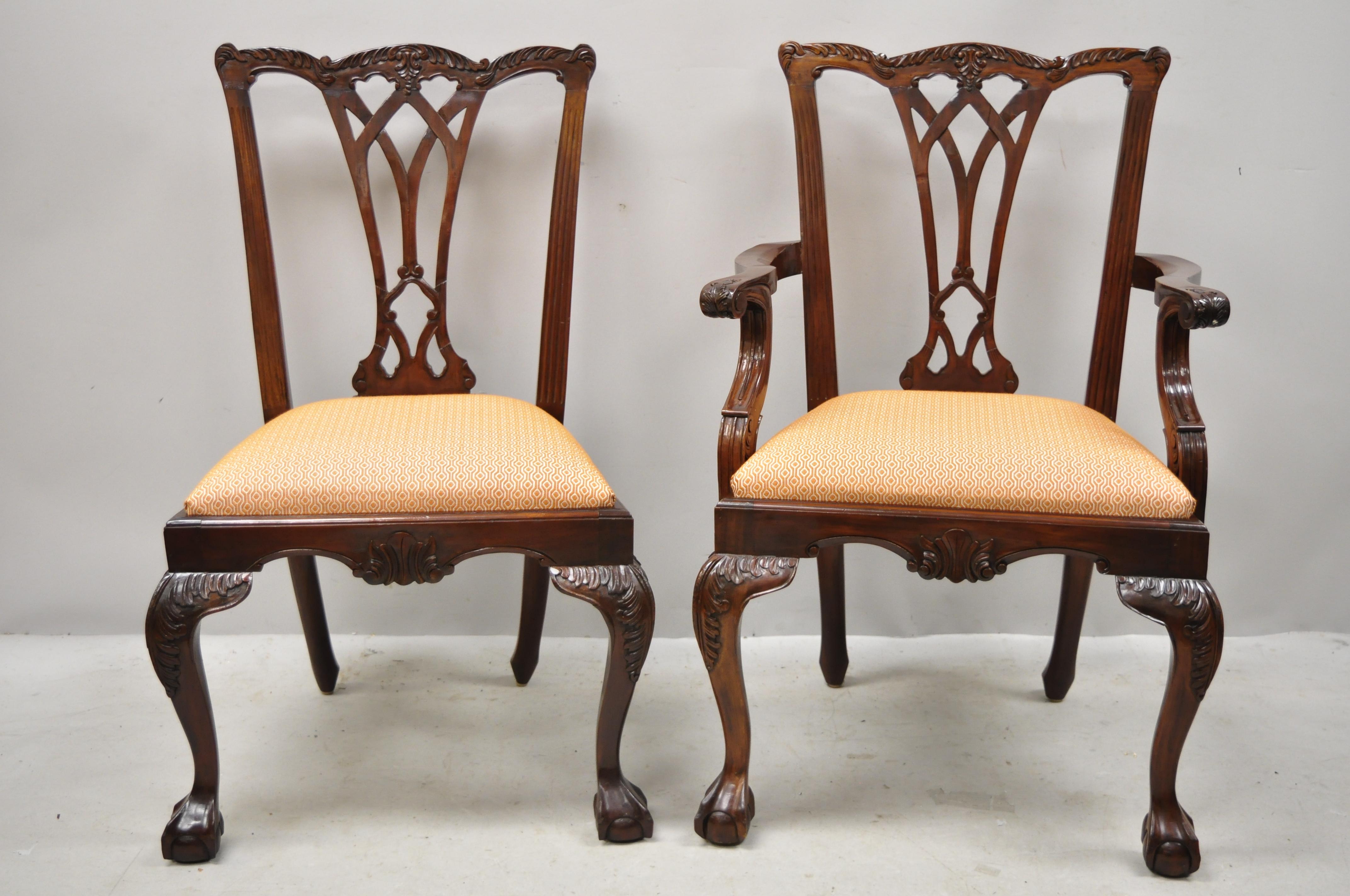 Late 20th century Chippendale style carved ball and claw mahogany dining chairs - set of 8. Set includes (2) armchairs, (6) side chairs, orange printed drop seats, solid wood construction, beautiful wood grain, nicely carved details, carved ball and