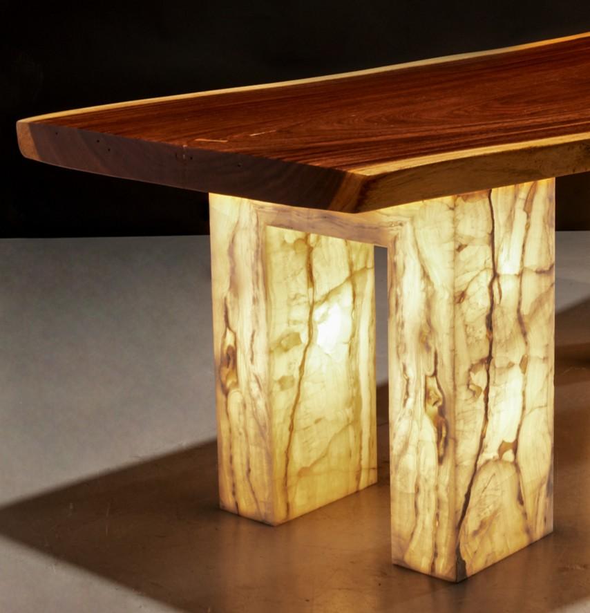 20th c., USA, a Christopher Guy Harrison (British, 1960-2020) custom designed table. The table features a natural-edged Hawaiian koa wood plank top, showcasing its rich grain and warm, golden hues. The live edge preserves the natural contours of the