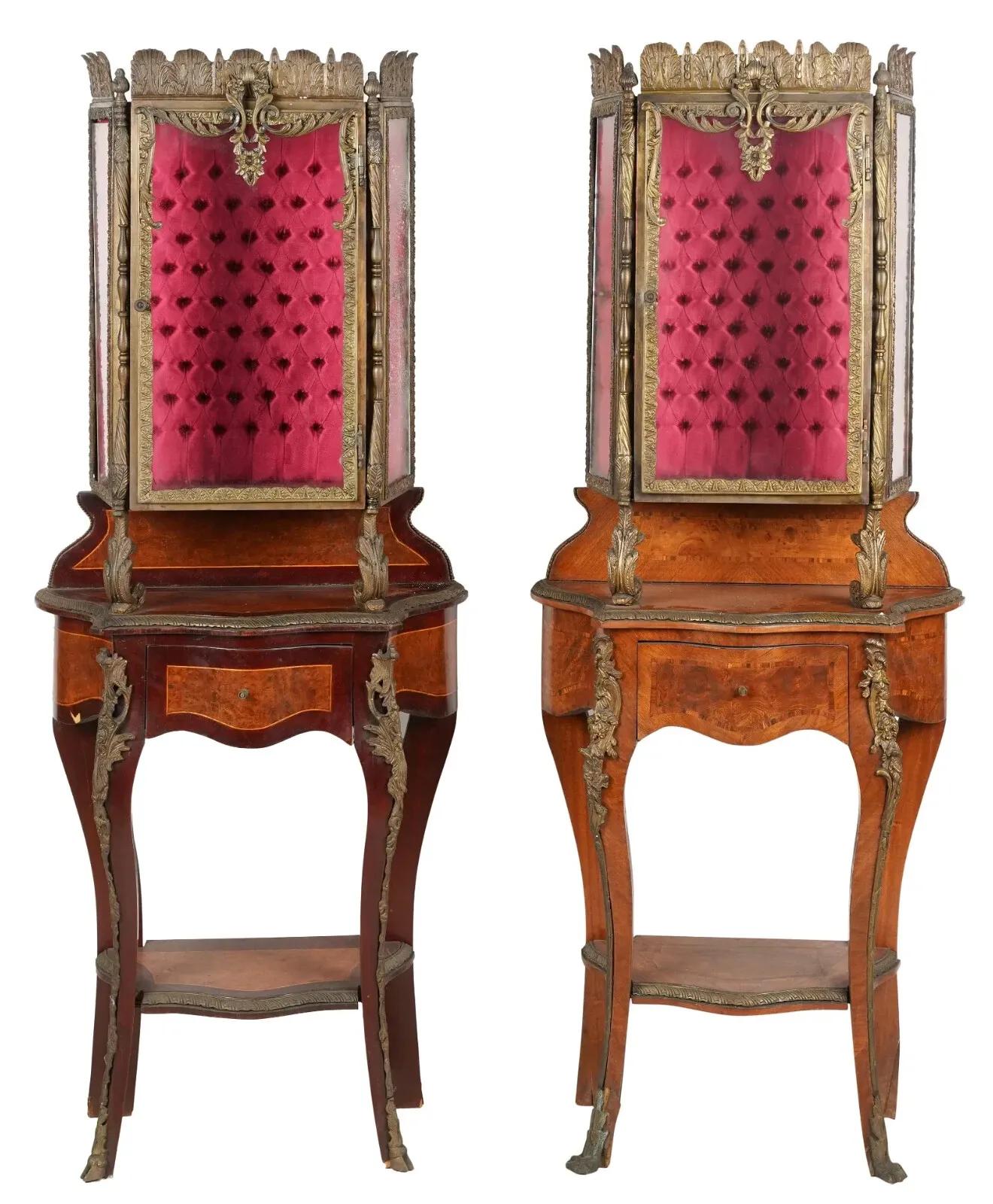 Gorgeous Pair of Vitrine Cabinets, Collection of Larry Flynt, Pair, Pink Background, Cross-Banded Borders and Metal Mounts,  Vintage!

This pair of vintage display cabinets, originally part of the Larry Flynt collection, exudes a timeless charm that