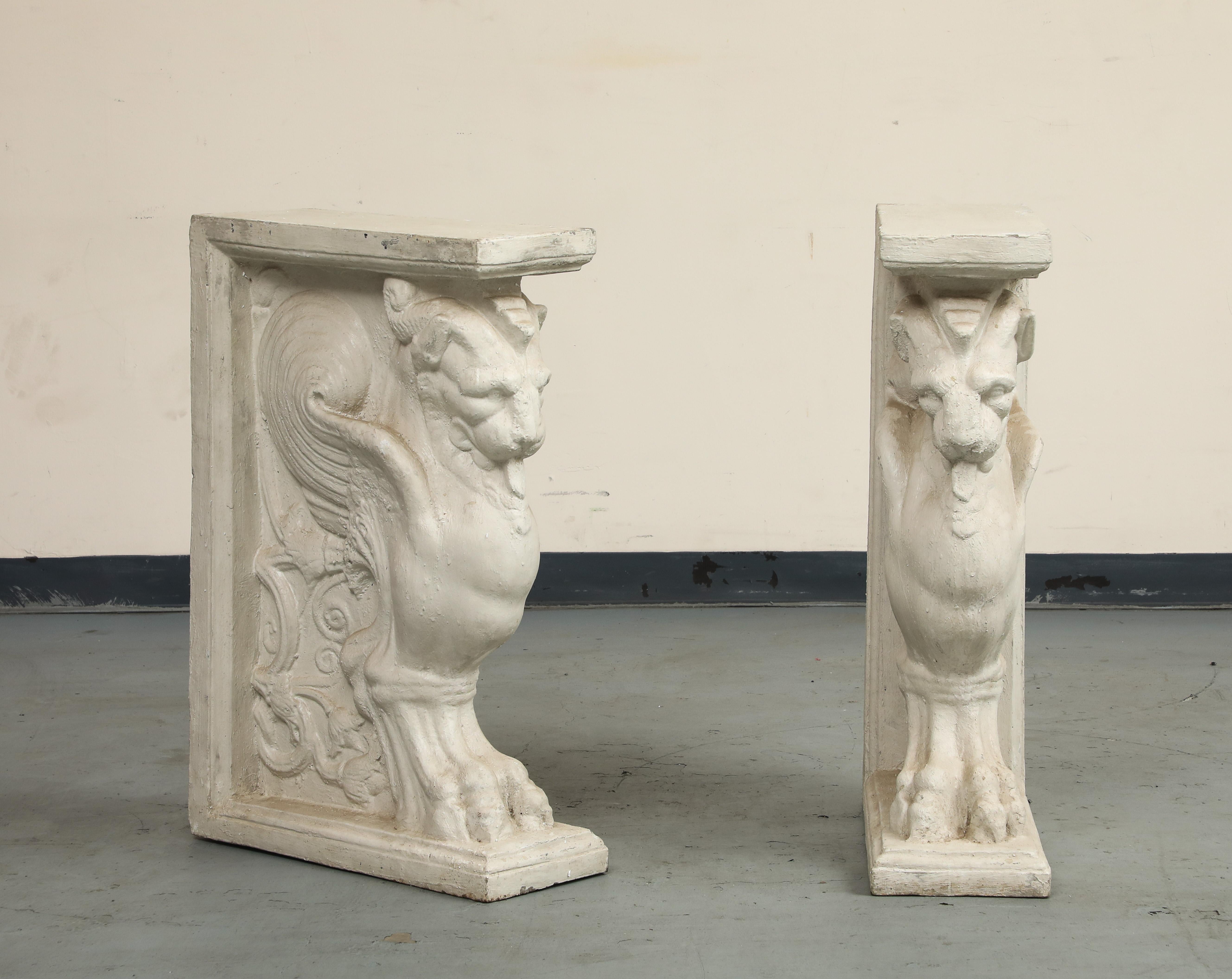 20th century marble-top console table with cast stone pedestals in the forms of winged lions/griffins. The mythological winged lion symbolizes St. Mark the Evangelist, the patron saint of the Republic of Venice. The design is reminiscent of the