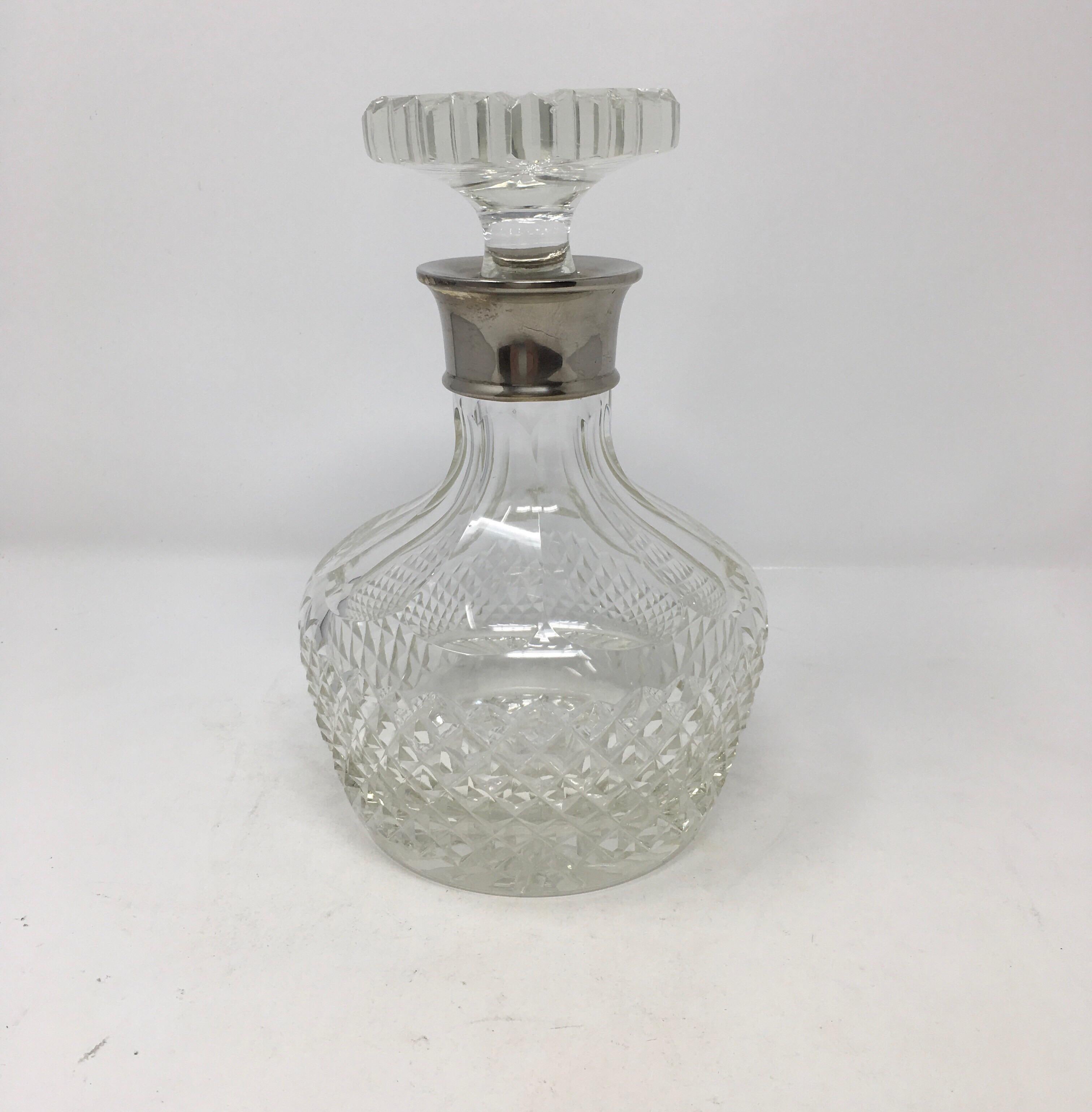 This is 20th century cut crystal whiskey decanter with silver plate collar and complete with stopper. Would be a beautiful addition to your bar or bar cart.