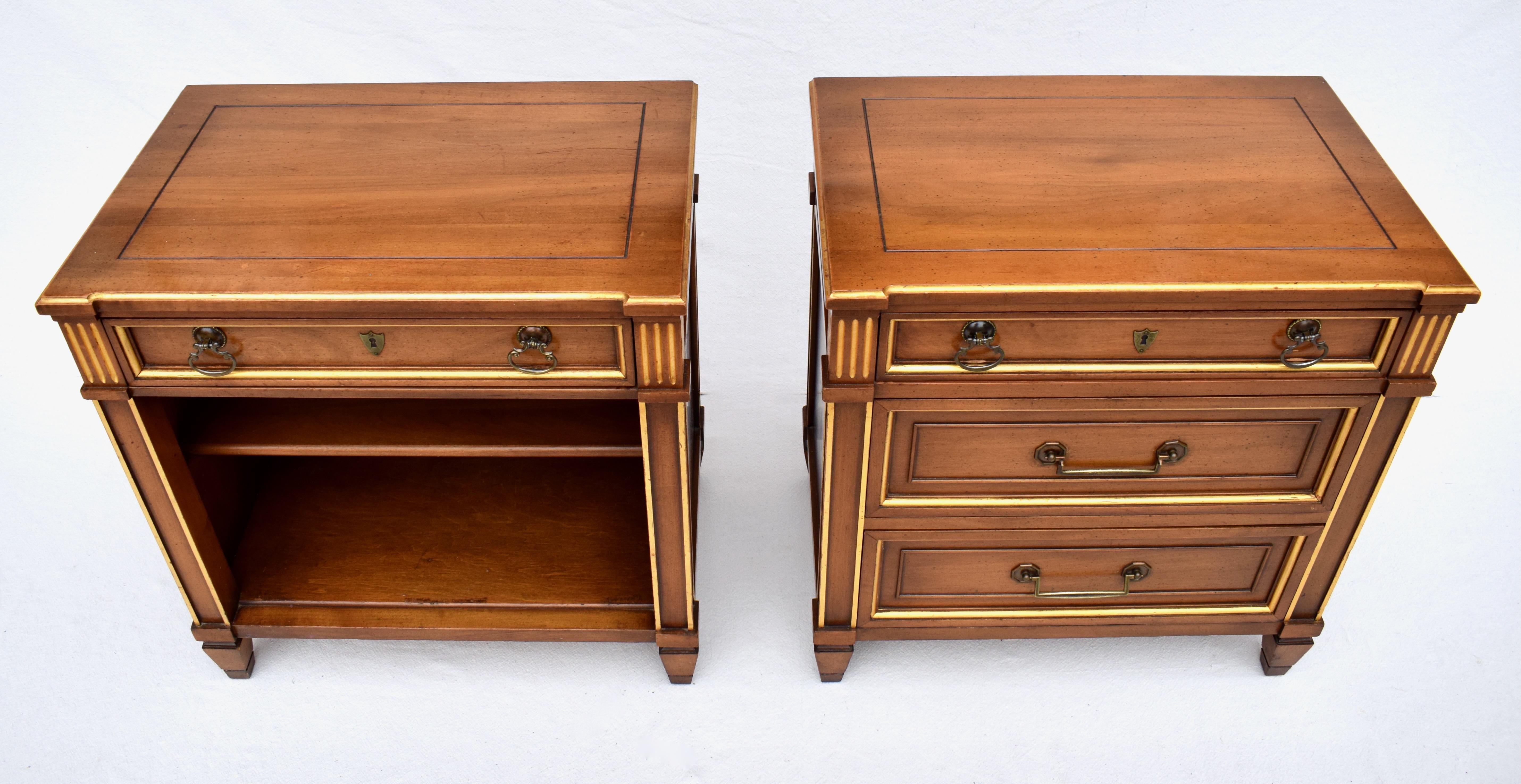 A pair of Italian Directoire style nightstands featuring notched tops with parcel gilt accents including fluted side posts raised on tapered feet. This is a matching pair in form, each having distinctly unique functional drawer & shelving options.