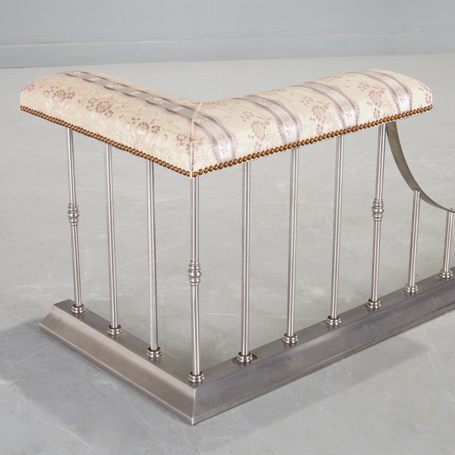 20th c., an Edwardian style English club fireplace fender with a modern twist. Made of steel with a padded silk taffeta seat board with nailhead trim, this fender is a sleek and elegant form of a traditional staple of the English country house, The