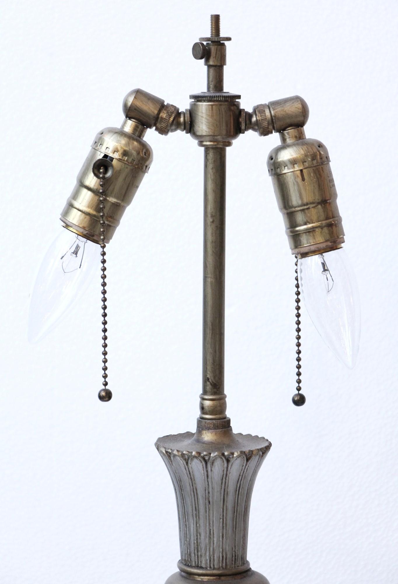 This 20th Century Georgian style lamp has a silver and gold finish over bronze. Comes with two adjustable sockets. Cleaned and rewired. Please note, this item is located in one of our NYC locations.
