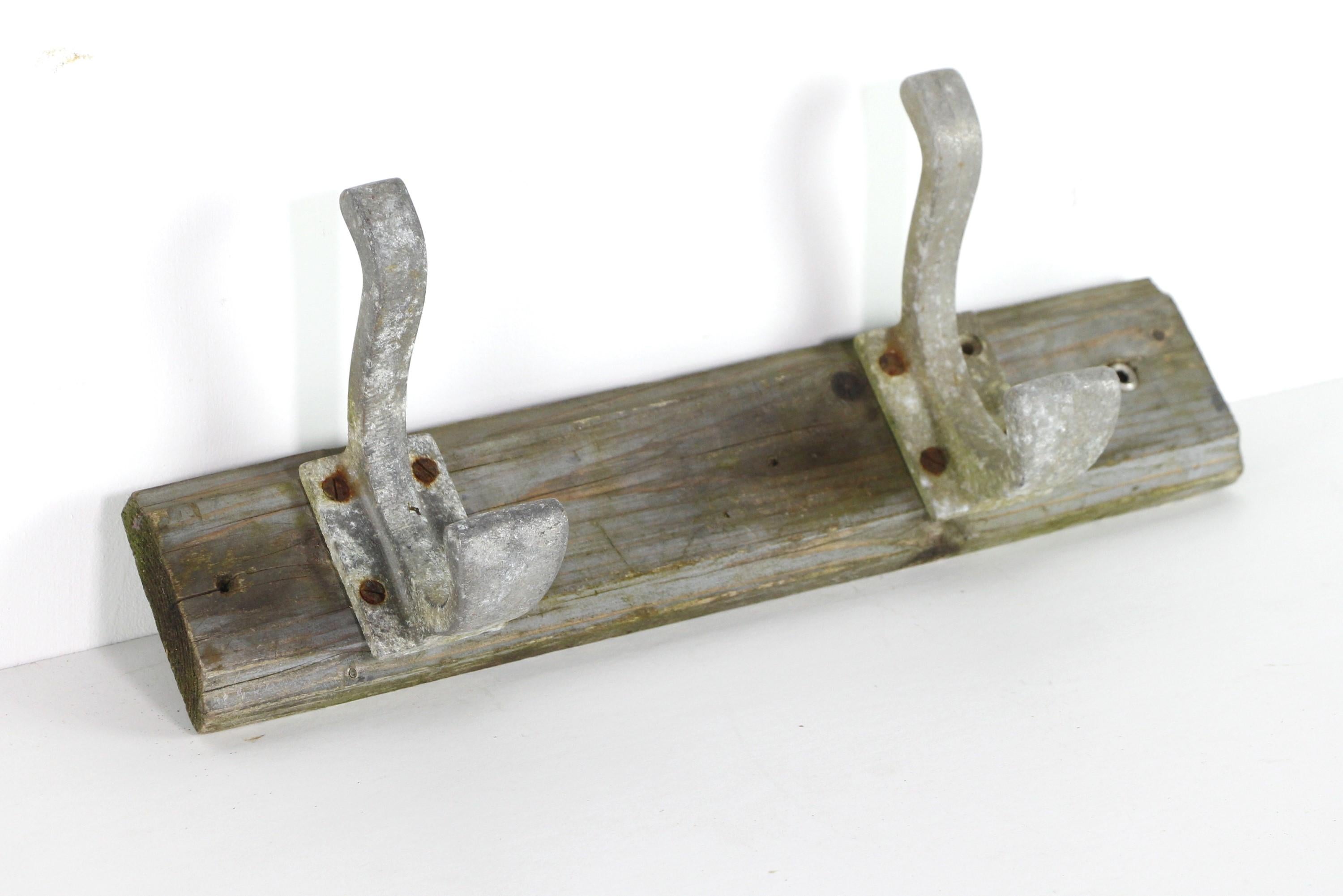 Two original Mid-Century Modern aluminum hooks mounted on a driftwood stained wood plank. Great for hats and coats. Please note, this item is located in our Scranton, PA location.