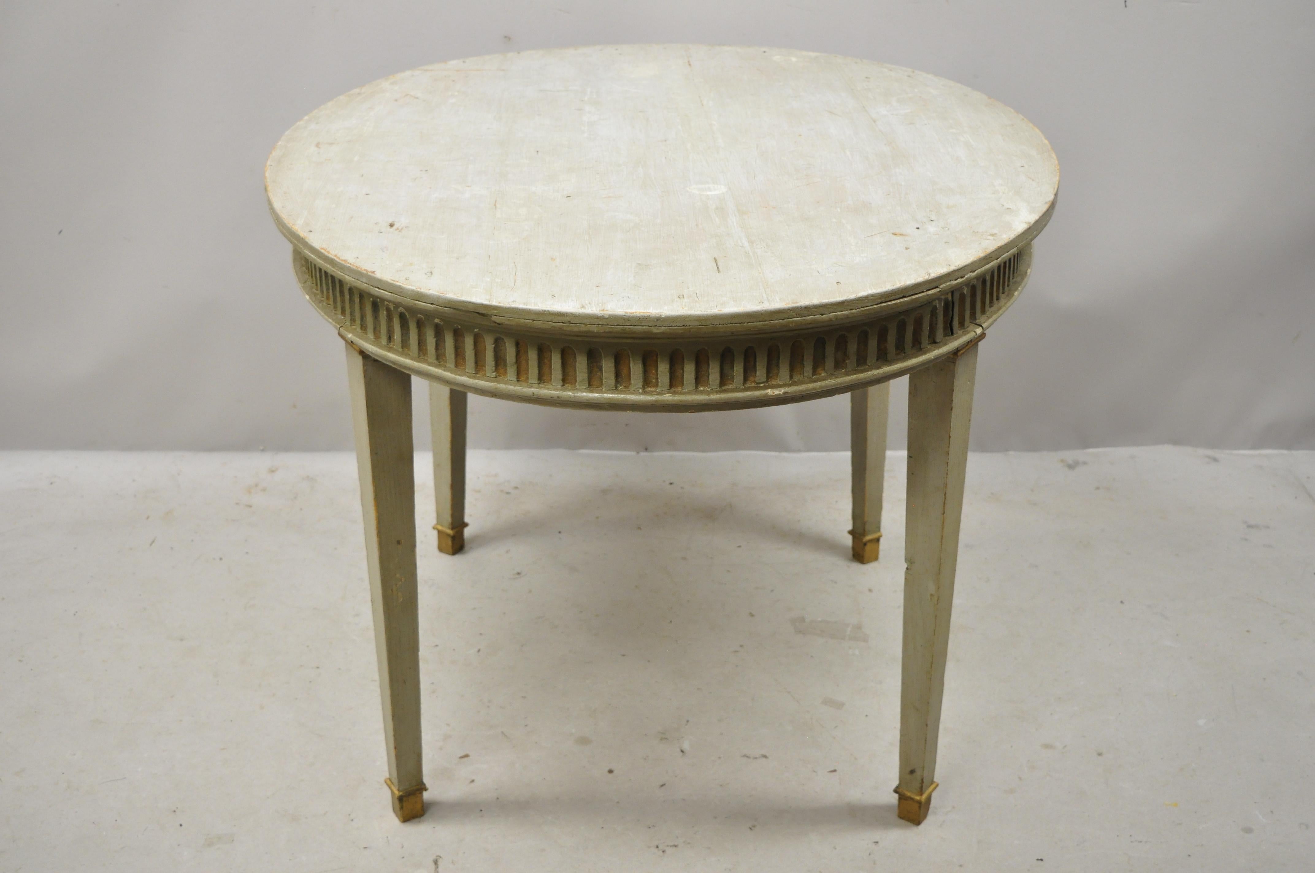 Early 20th century French Louis XVI style distressed green painted small oval dining table. Item features an oval top, gold gilt accents, green distressed finish, nicely carved details, tapered legs, very nice antique item. Probably had another top