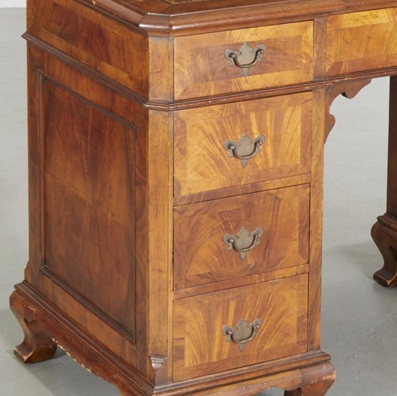 Early 20th century, nice quality, double pedestal writing desk, with gold embossed leather inset writing surface, all in one piece, on bracket feet, unmarked. The drawers have dovetail joints, figured mahogany fronts and classic brass Chippendale