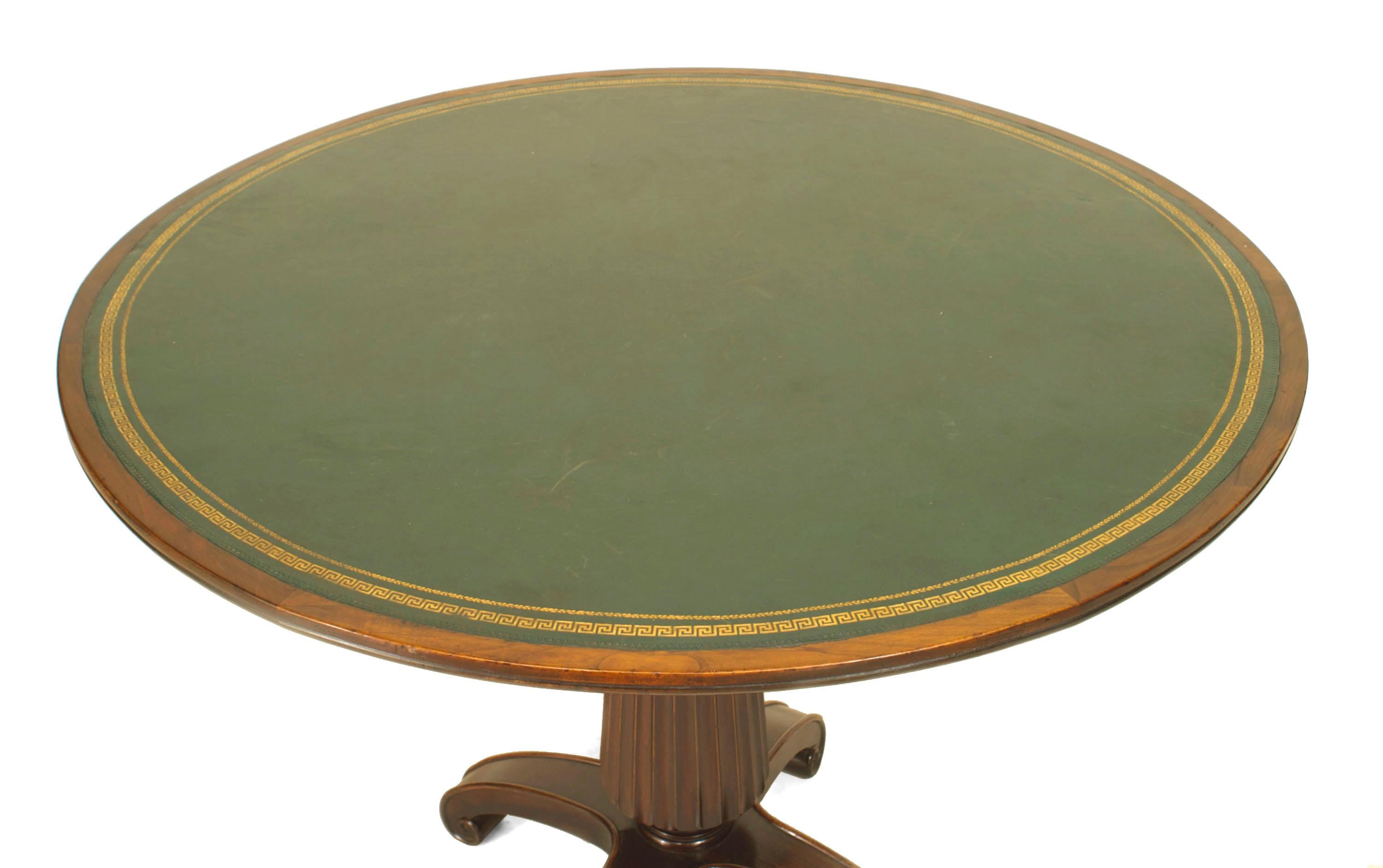 Twentieth century English Georgian style mahogany game table with a fluted tripod pedestal base supporting a round top inset with green leather.