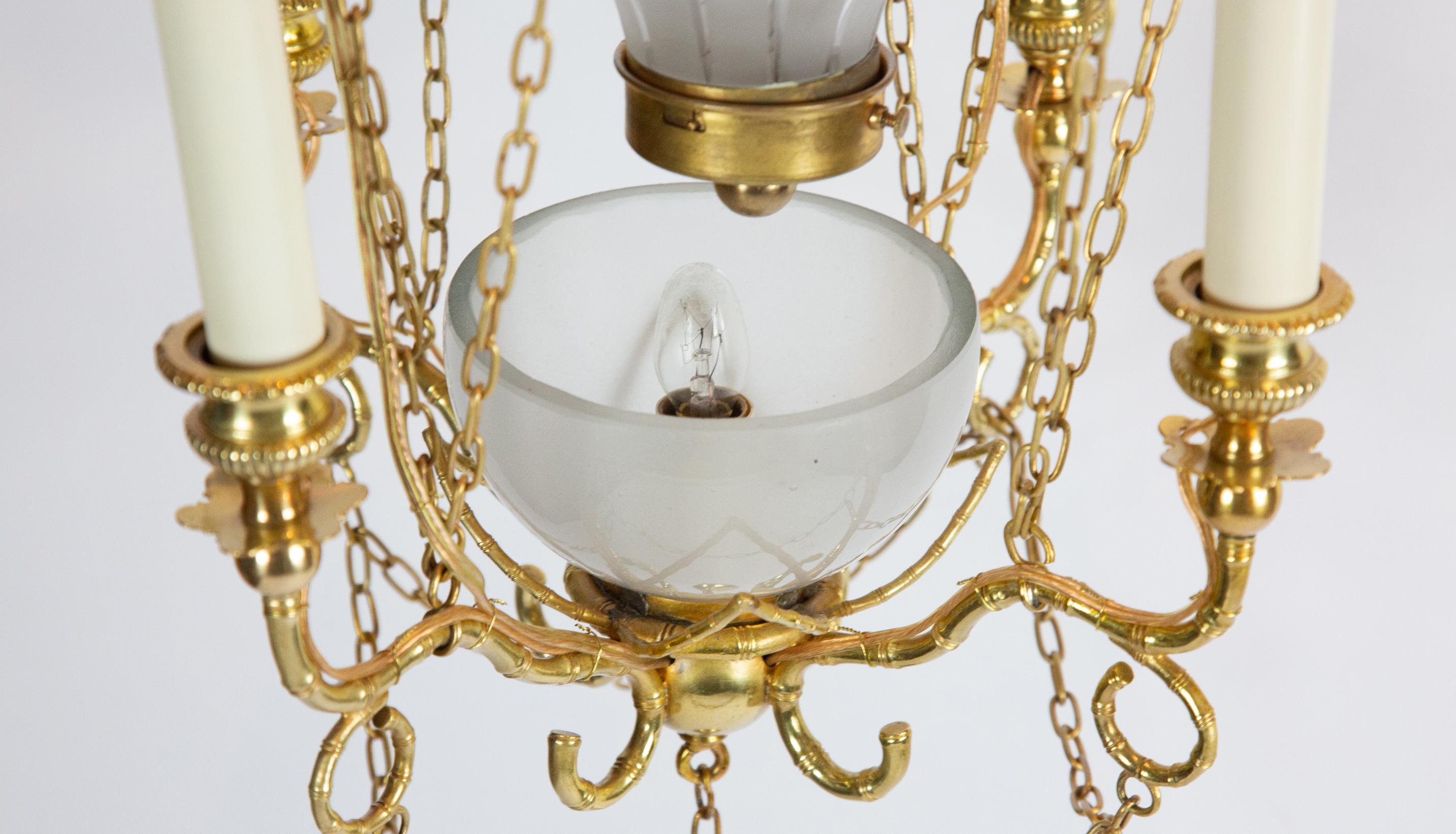 20th century gilt five-light ormolu and glass Montgolfier hot air balloon chandelier. Four arms, with one light in center frosted glass enclosure. Inspired by Montgolfier-style hot air balloon, the first practical hot air balloon, invented by the