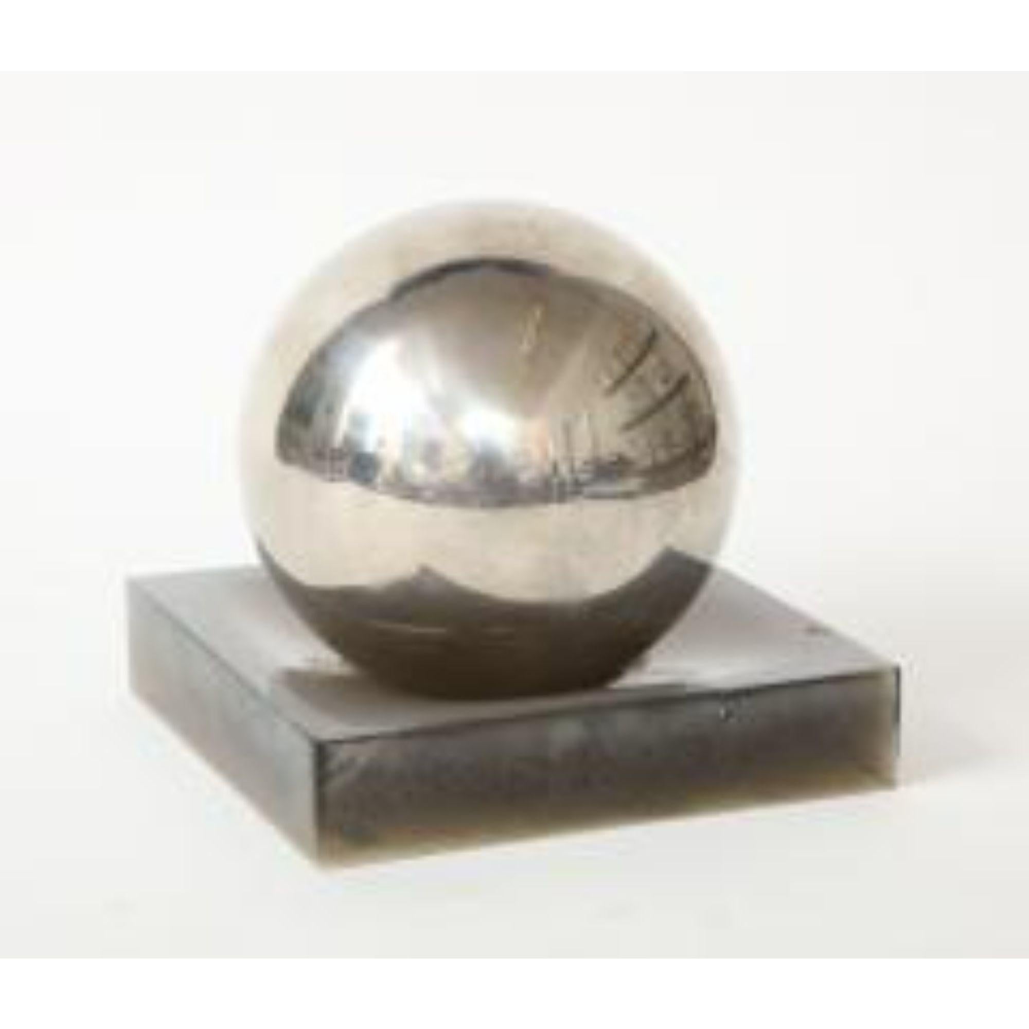 Silver Ball on Lucite Base

Round silver ball sits on a square Lucite base finished in a dark smoked grey.
Modernist in composition, this pair makes for a sleek and highly sculptural decorative object.