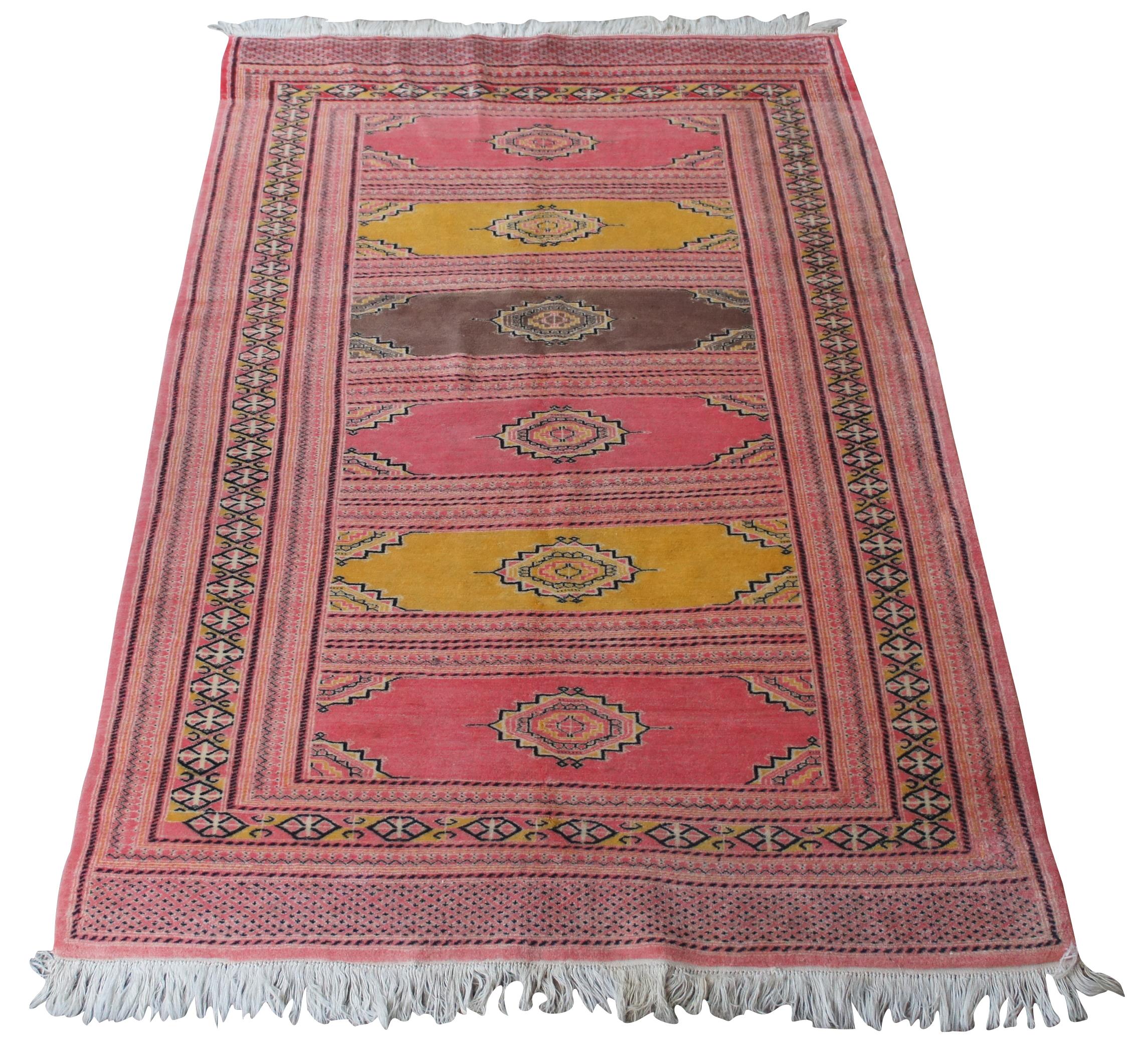 A stunning mid 20th century pakistani prayer rug with a pink color pallette containing a pattern of six niches designed after the mihrab of a mosque. Features shades of pink, yellow, brown and black. 

Provenance: Estate of Carol Levitan and Jesse