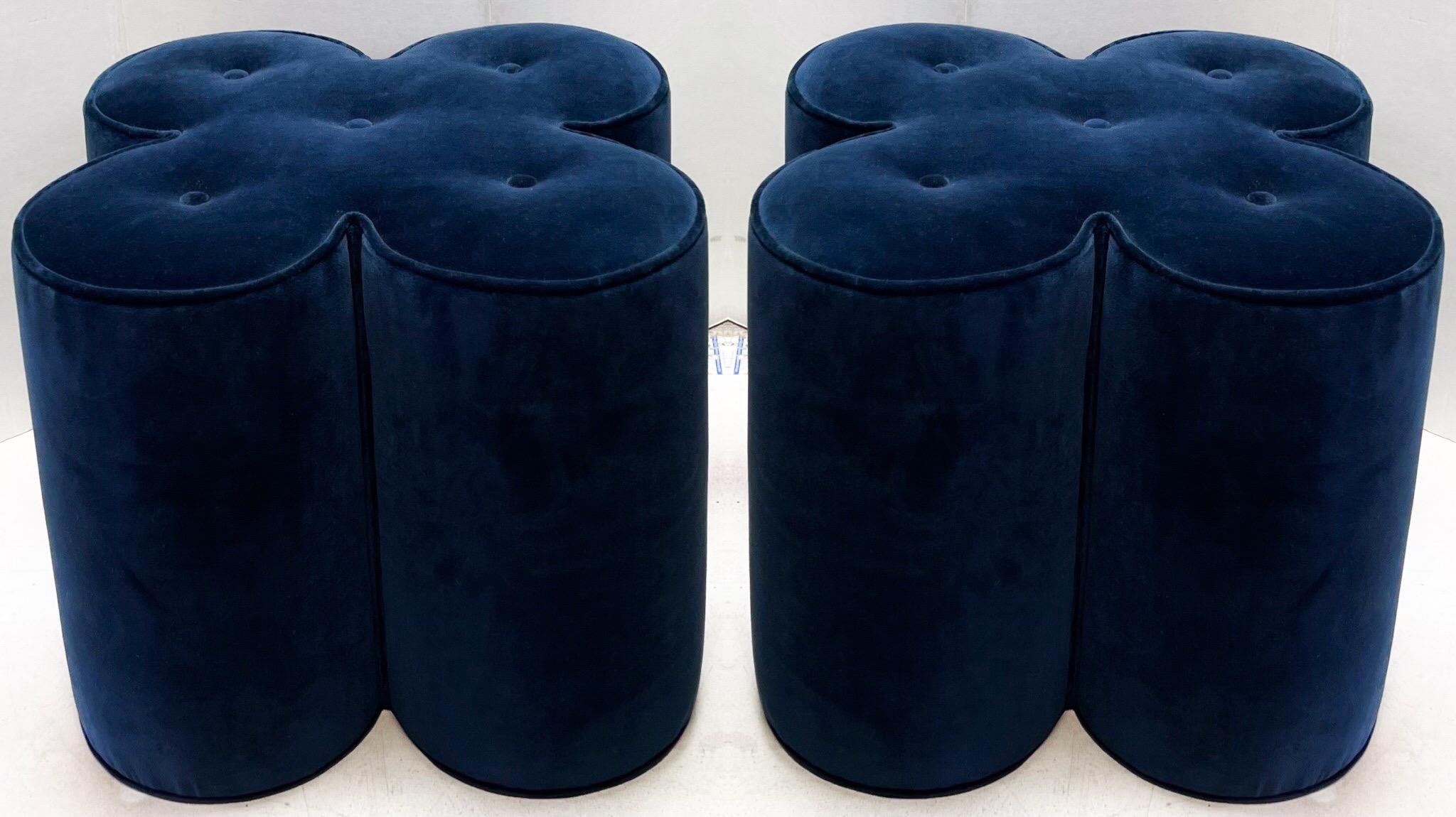 These are fun! The offering is a pair of tufted navy velvet floral form ottomans. They are unmarked and in very good condition.