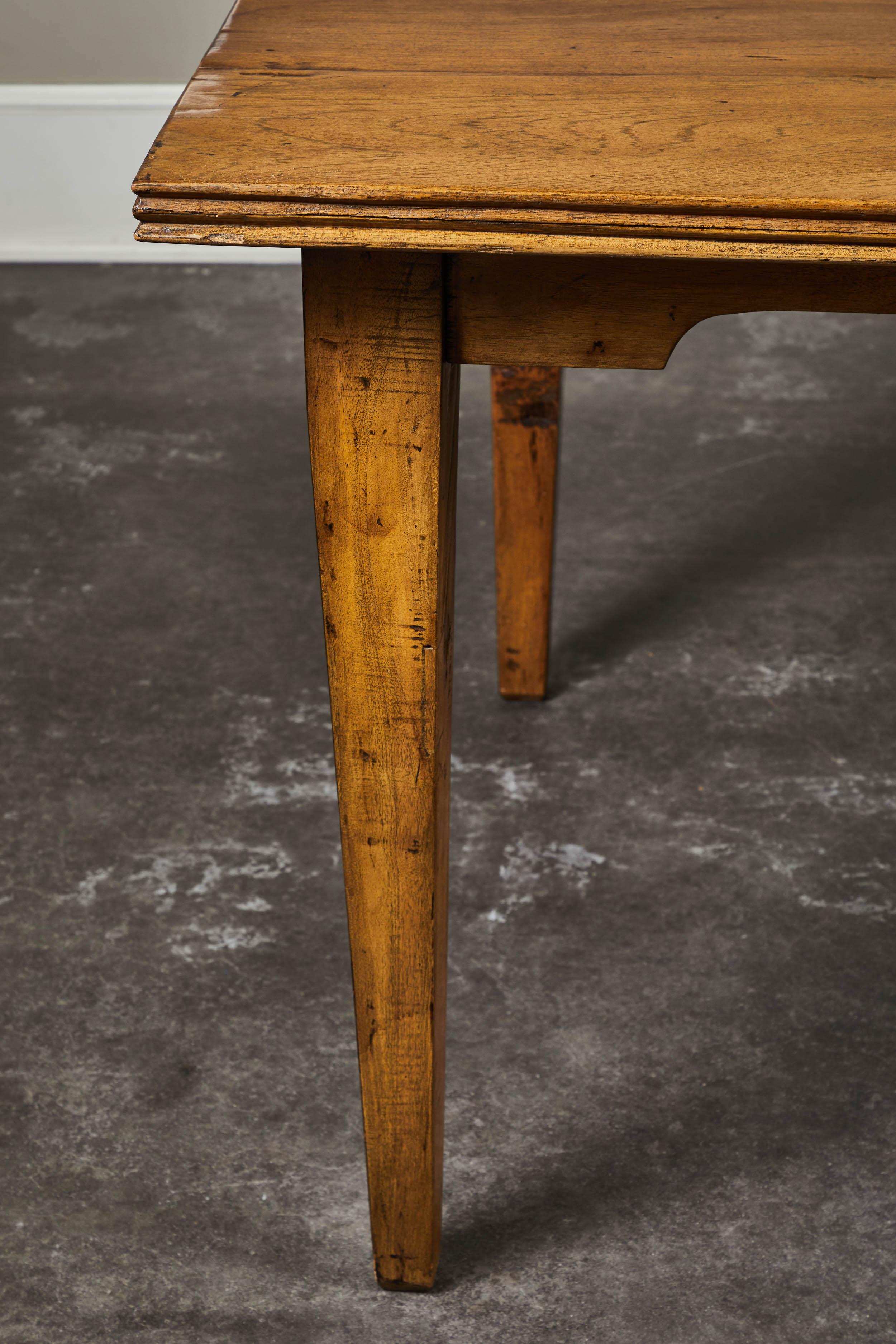 A 20th century Indonesian teak dining table. Thick old growth 1.5” teak planks, with rustic ridged detailing along edge. Soft apron and farmhouse style allows ample room for armchairs.