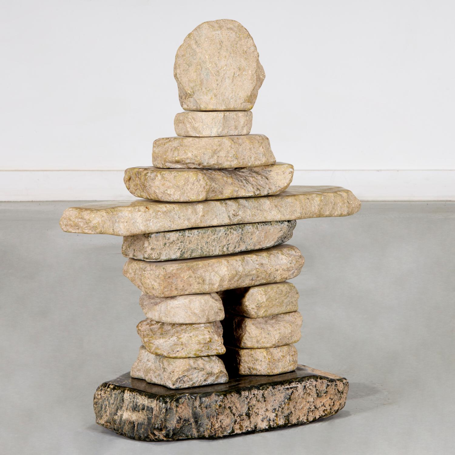 20th c., Pacific Northwest, a large stacked stone Inuit Peoples Inuksuk in the form of a human, on a polished stone base. The underside of the stacked stones are polished while the top and sides remain in their original rough form.

This Inuksuk is
