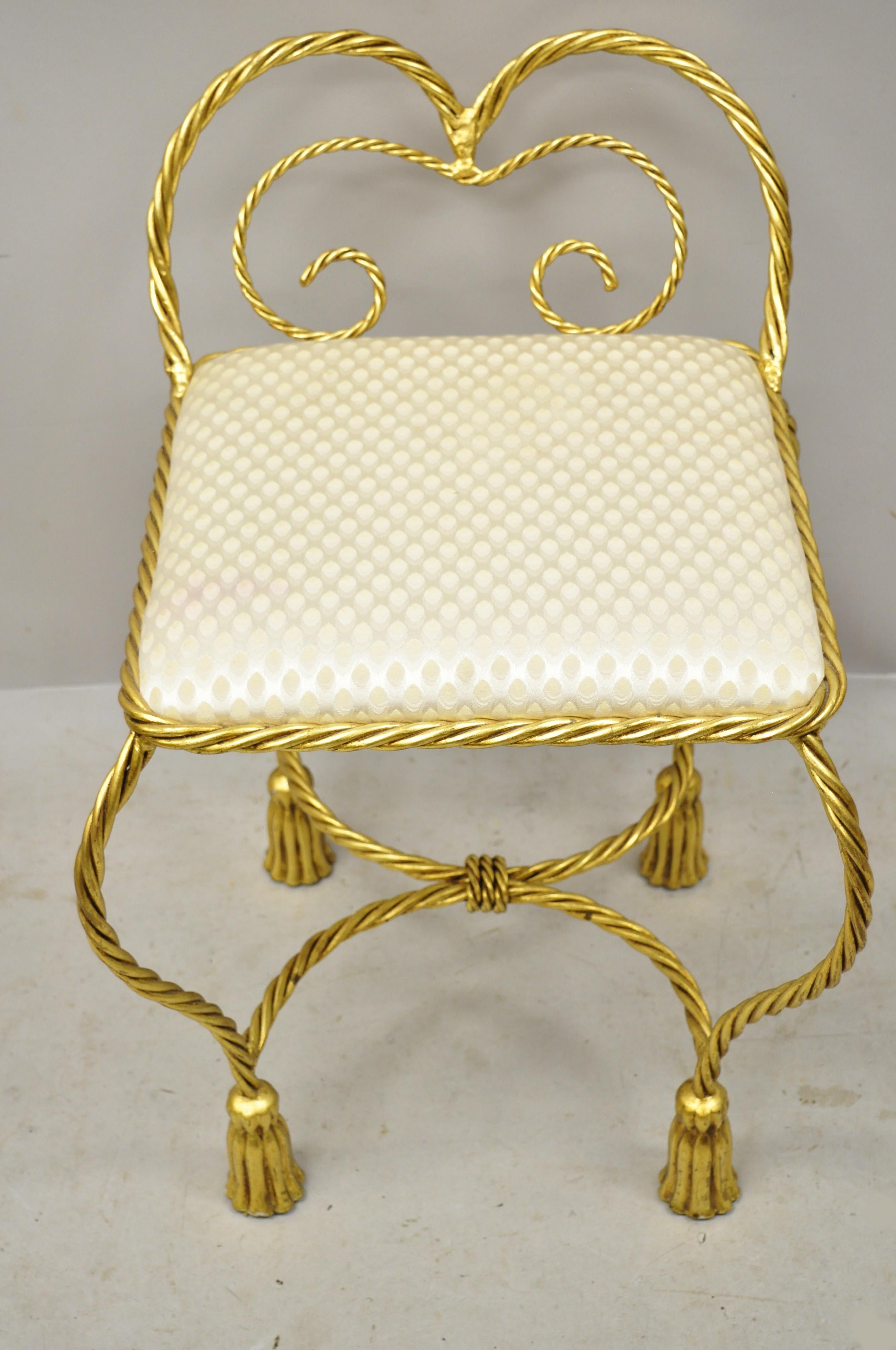 Mid-20th century Italian Hollywood Regency gold gilt iron rope tassel small vanity chair. Item features a gold gilt iron frame, rope and tassel design, upholstered seat, very nice vintage item, great style and form, circa mid-20th century.