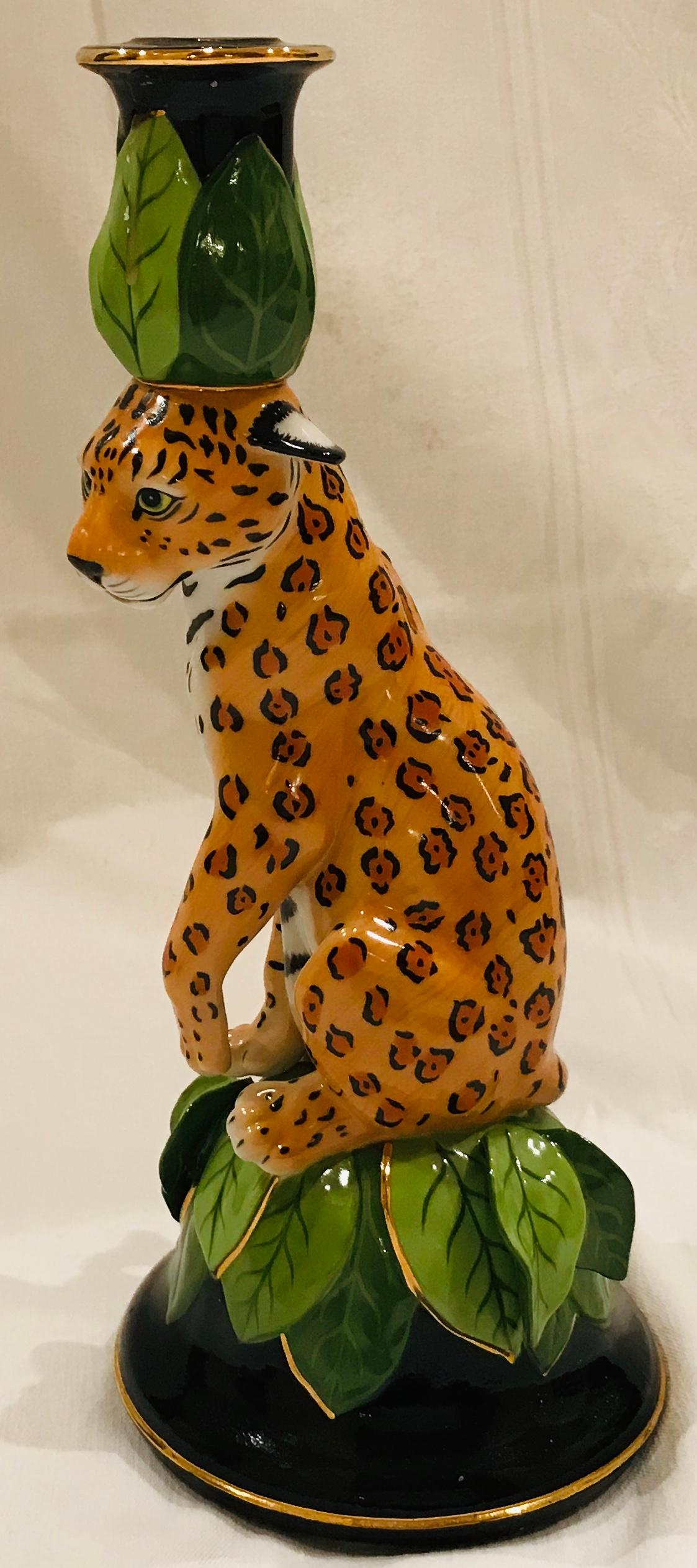 Jaguar jungle, a colorful ceramic candleholder-sculpture of a fanciful seated Jaguar, paw raised as if about to clean his face, wearing a leaf headpiece (that holds the candle), is a Classic whimsical piece by the artist Lynn Chase. 24-karat gold