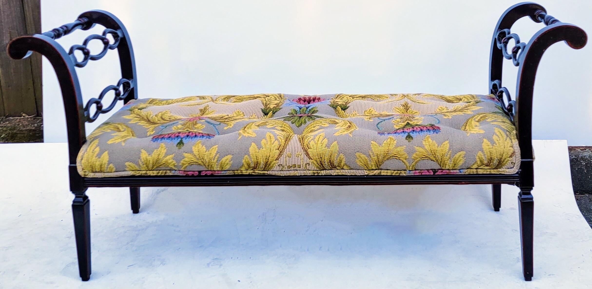 This is a lovely bench in a nice size! It has regency styling with it’s black lacquer painted frame and subtle red accents. The vintage upholstery is in very good condition and is a tapestry. The tapestry is taupe with gold, pink and blue