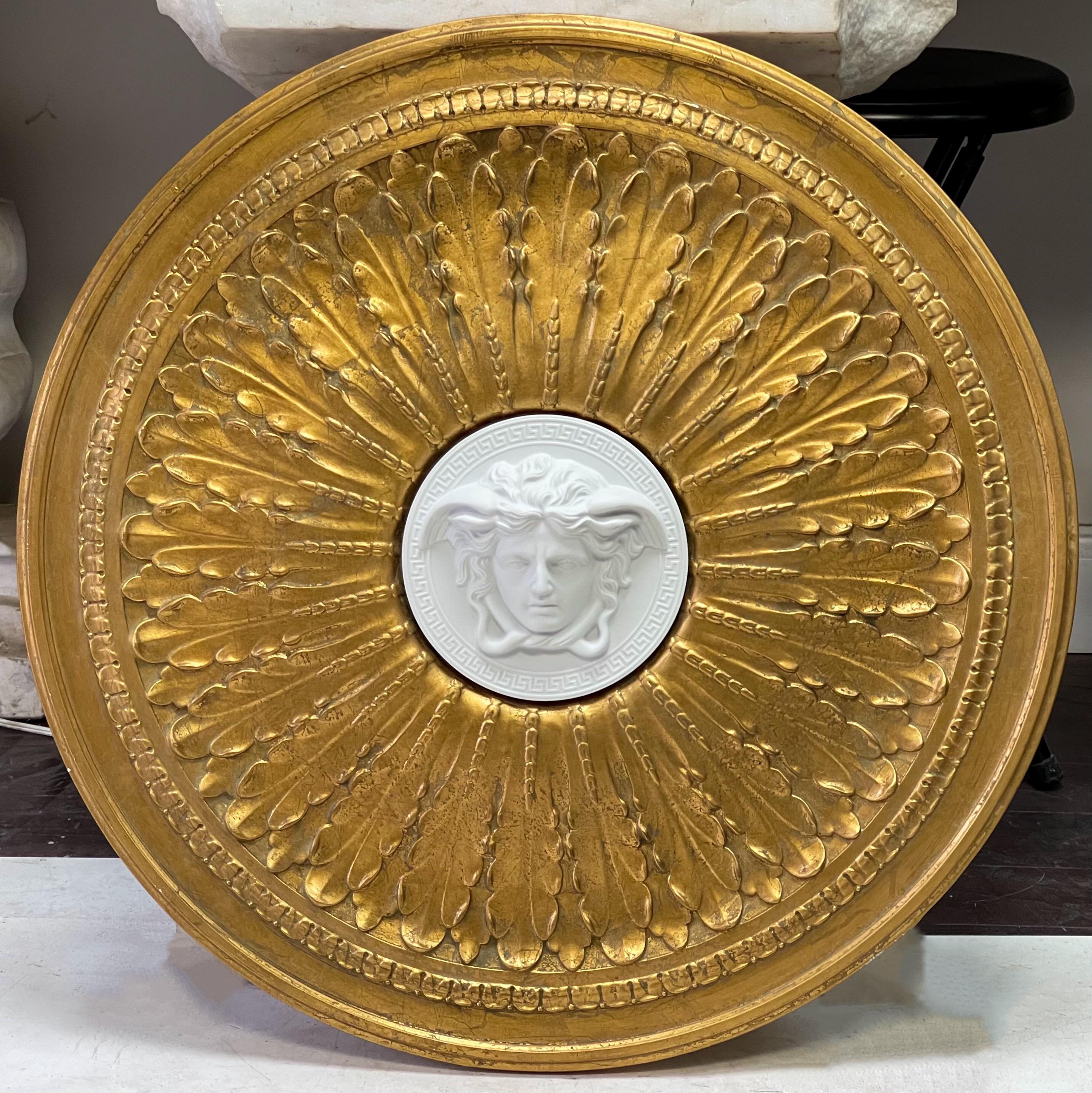 This is a late 20th century gilded neo-classical ceiling medallion designed by Versace for Rosenthal. It has a great look! I believe it could act as wall art too. It is marked and in very good condition. It is composition.