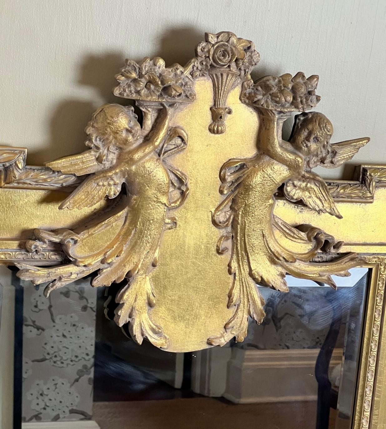 Beveled 20th C. Neoclassical Style Giltwood Mirror with Cherub and Floral Decoration For Sale