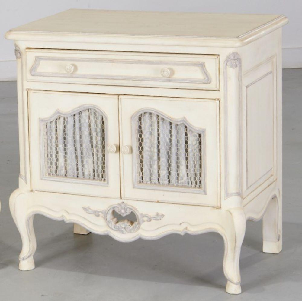20th c., custom pair of Louis XV style nightstands. Of high quality manufacture, these nightstands are painted a distressed white and have chicken wire cabinet doors with blue and white damask fabric door lining, below a single drawer,